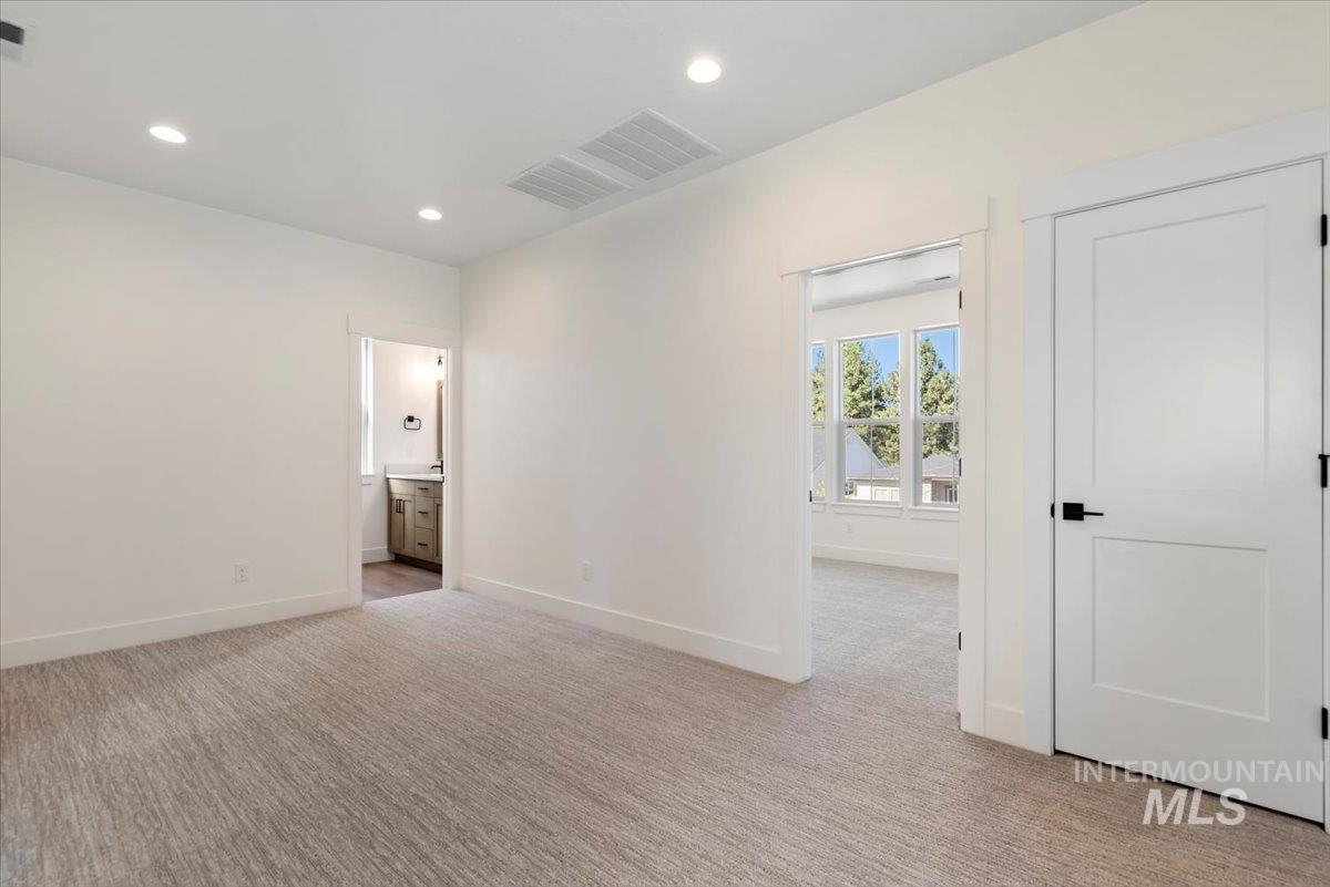 Empty room featuring light carpet and recessed lighting