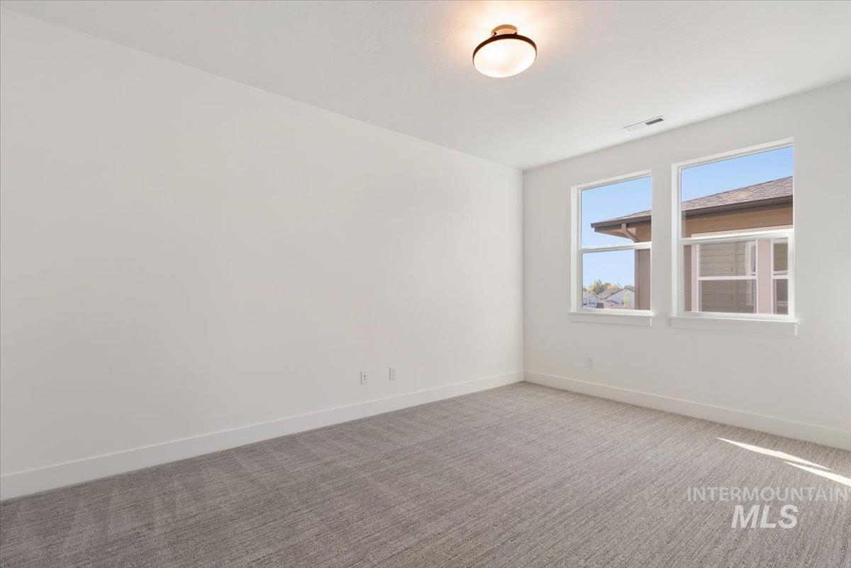 Empty room with carpet flooring and baseboards