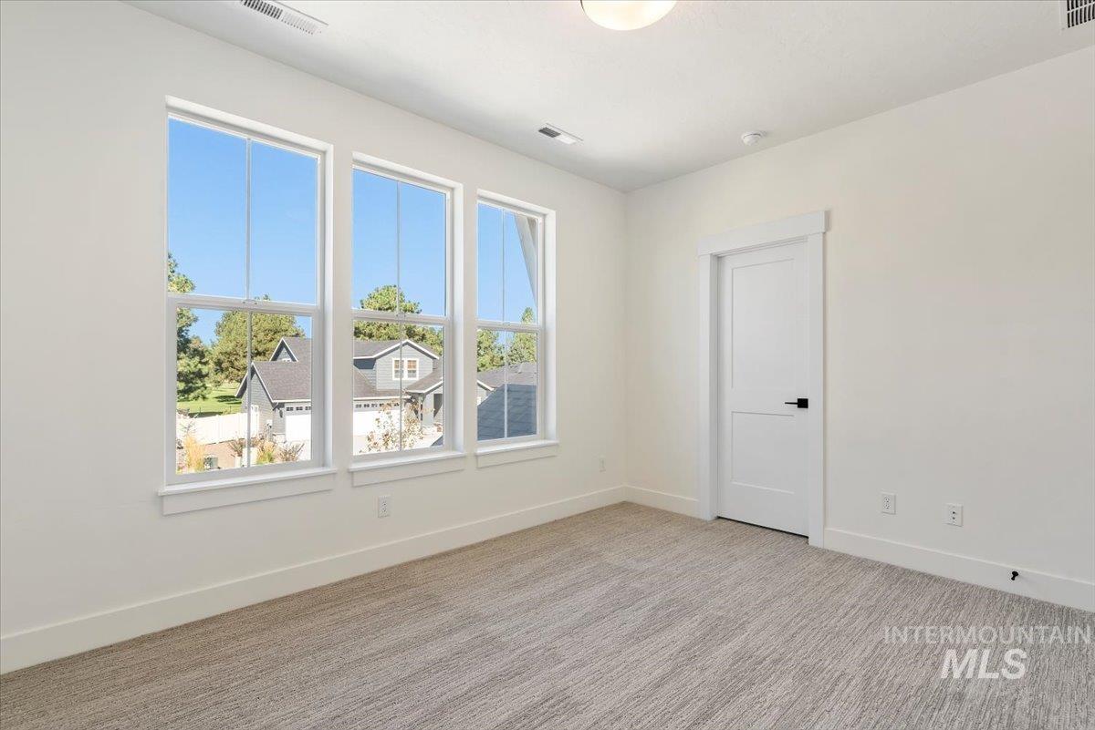 Unfurnished room with light carpet and baseboards