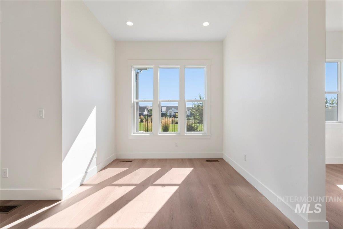 Spare room featuring light wood-style flooring and recessed lighting