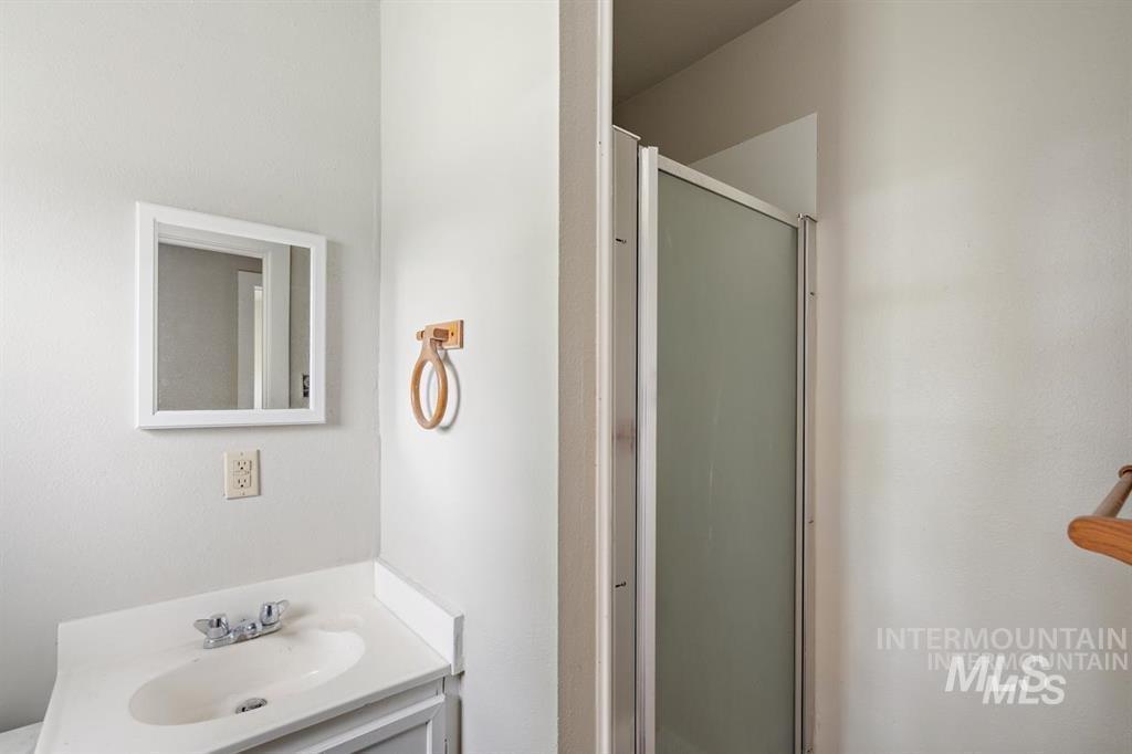 Bathroom with a shower stall and vanity