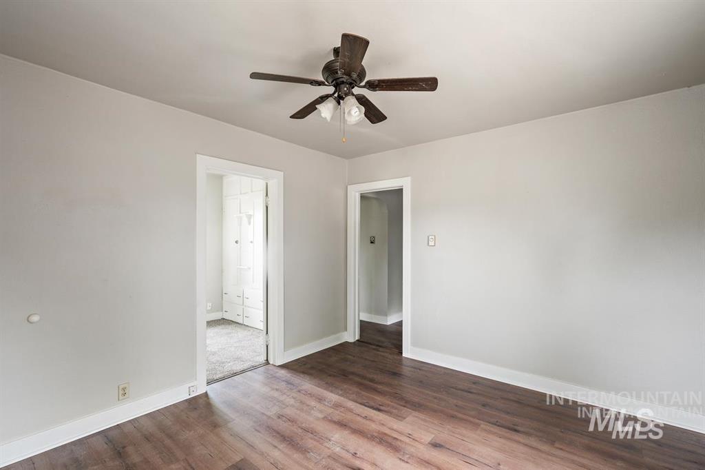 Unfurnished room with wood finished floors and ceiling fan