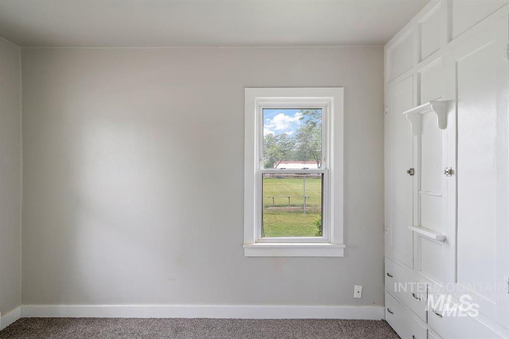 Empty room with baseboards and carpet floors
