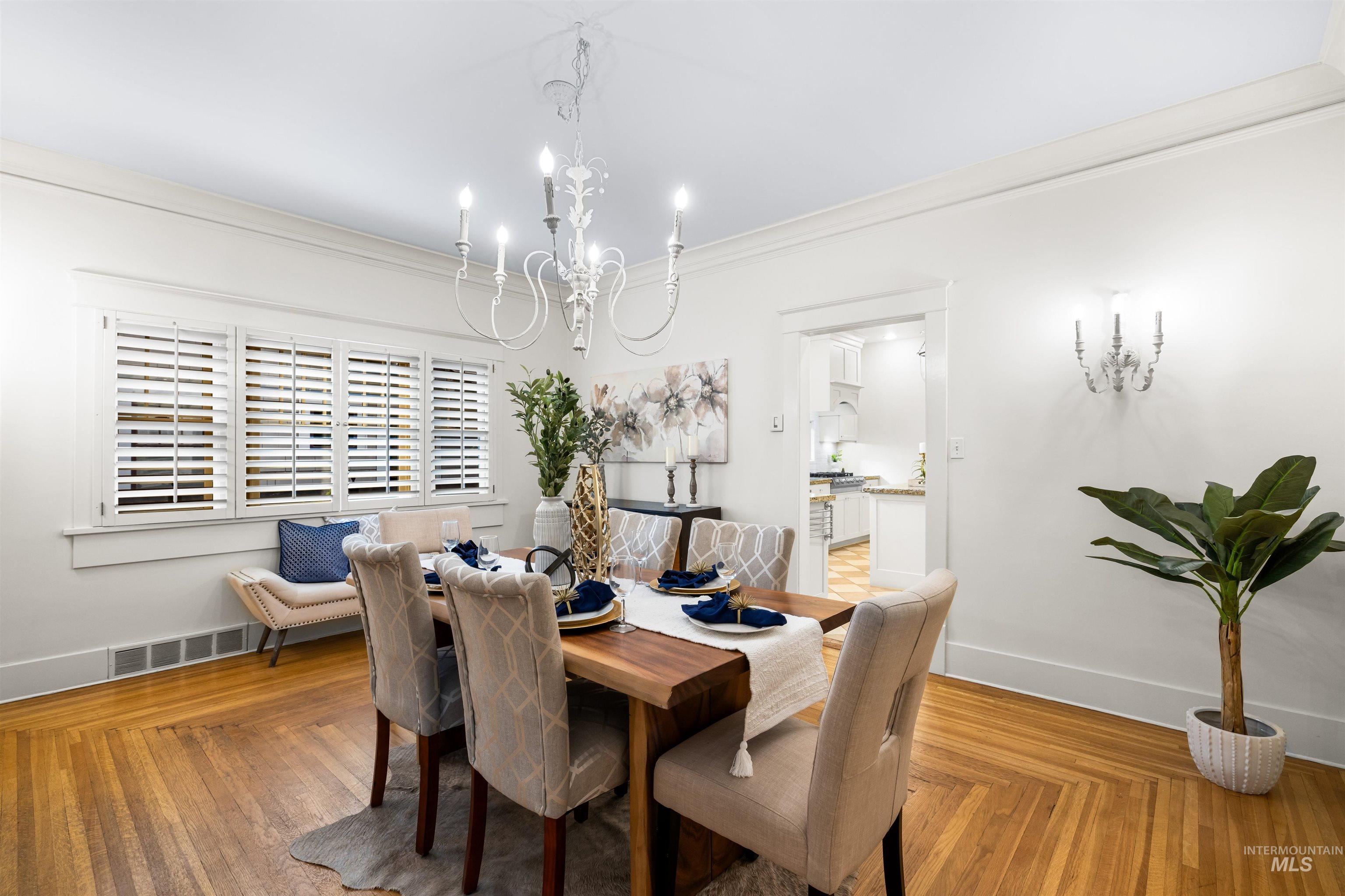 Dining room featuring ornamental molding and a chandelier