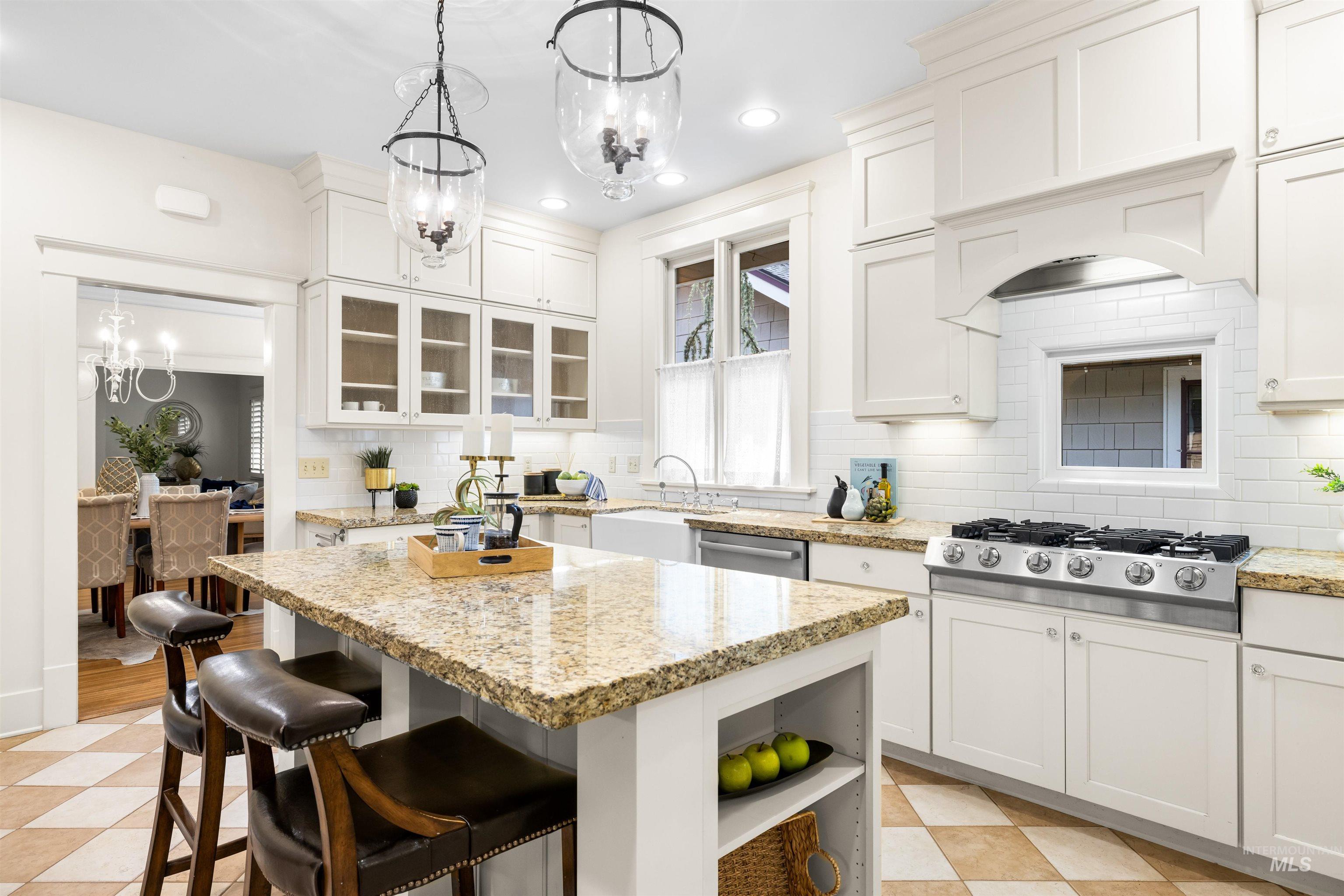 Kitchen with hanging light fixtures, open shelves, tasteful backsplash, a chandelier, and recessed lighting