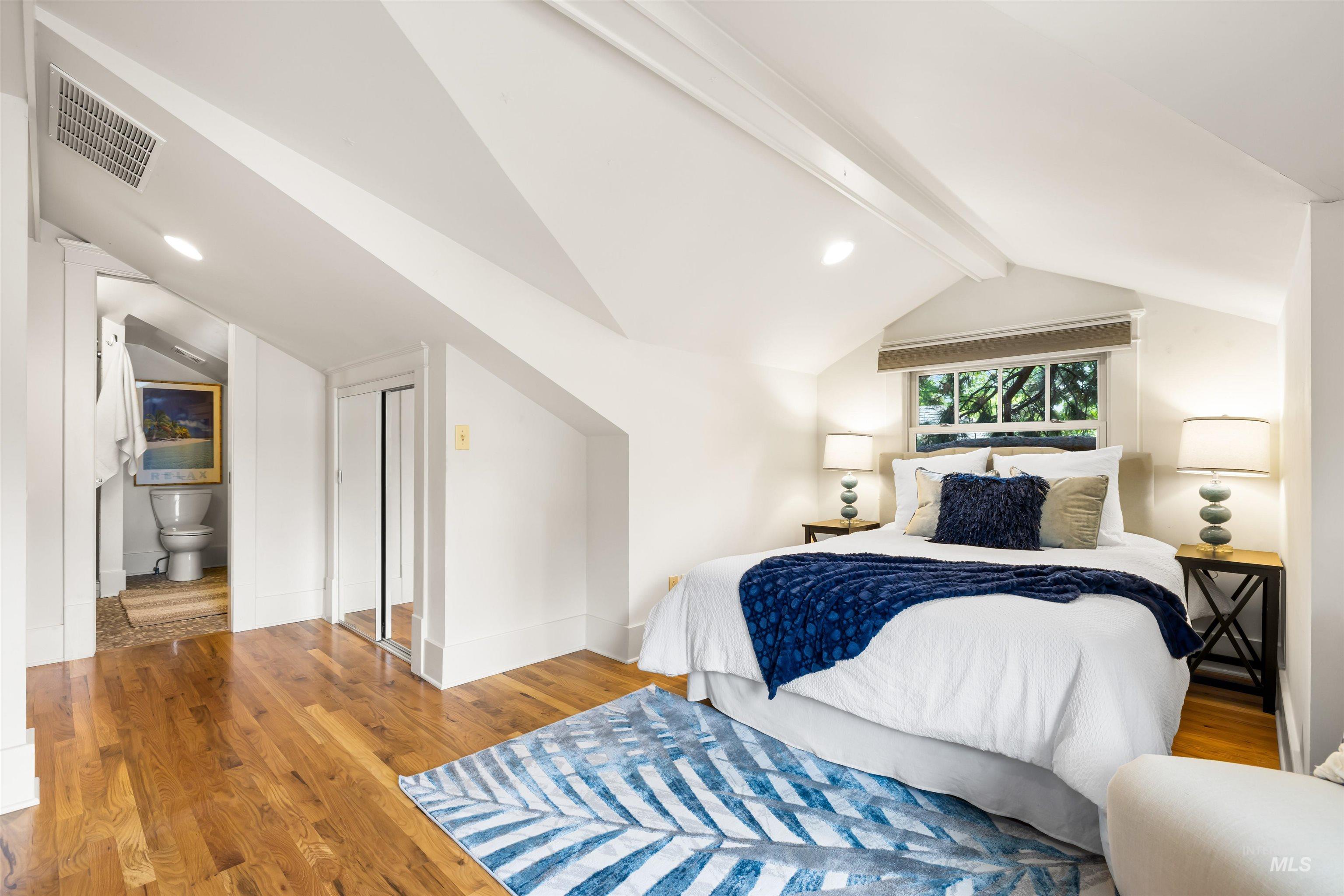 Bedroom with wood finished floors, a closet, and recessed lighting