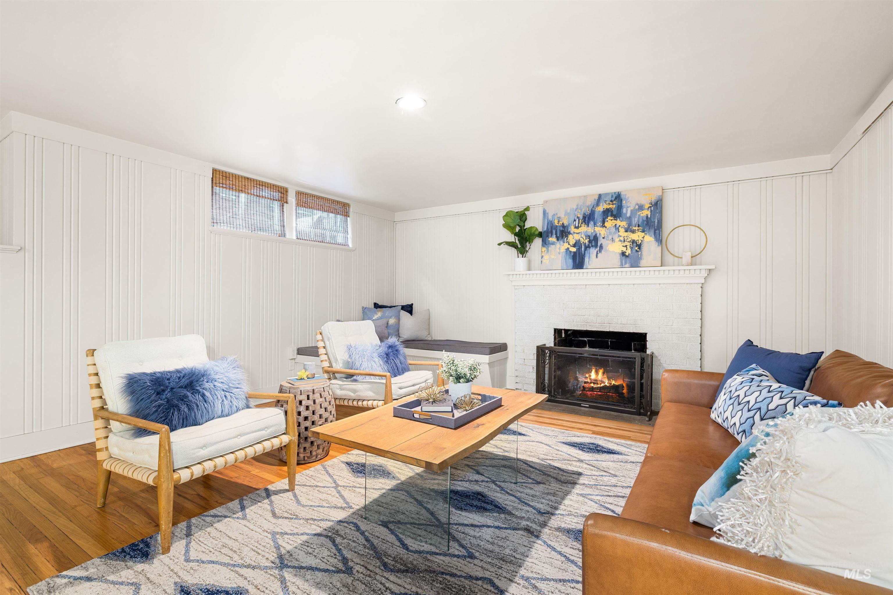 Living area featuring wood finished floors and a brick fireplace