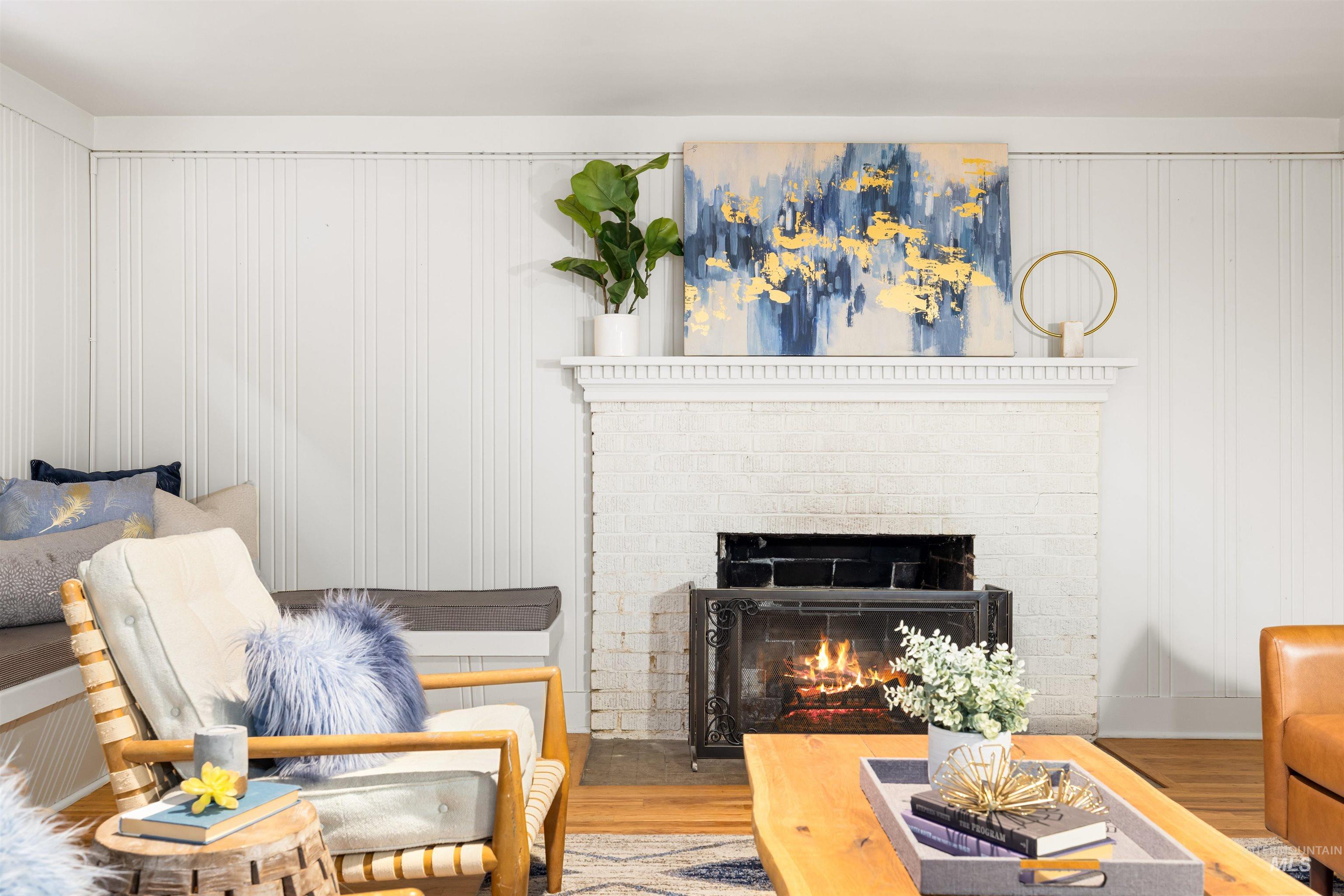 Living room featuring wood finished floors and a fireplace