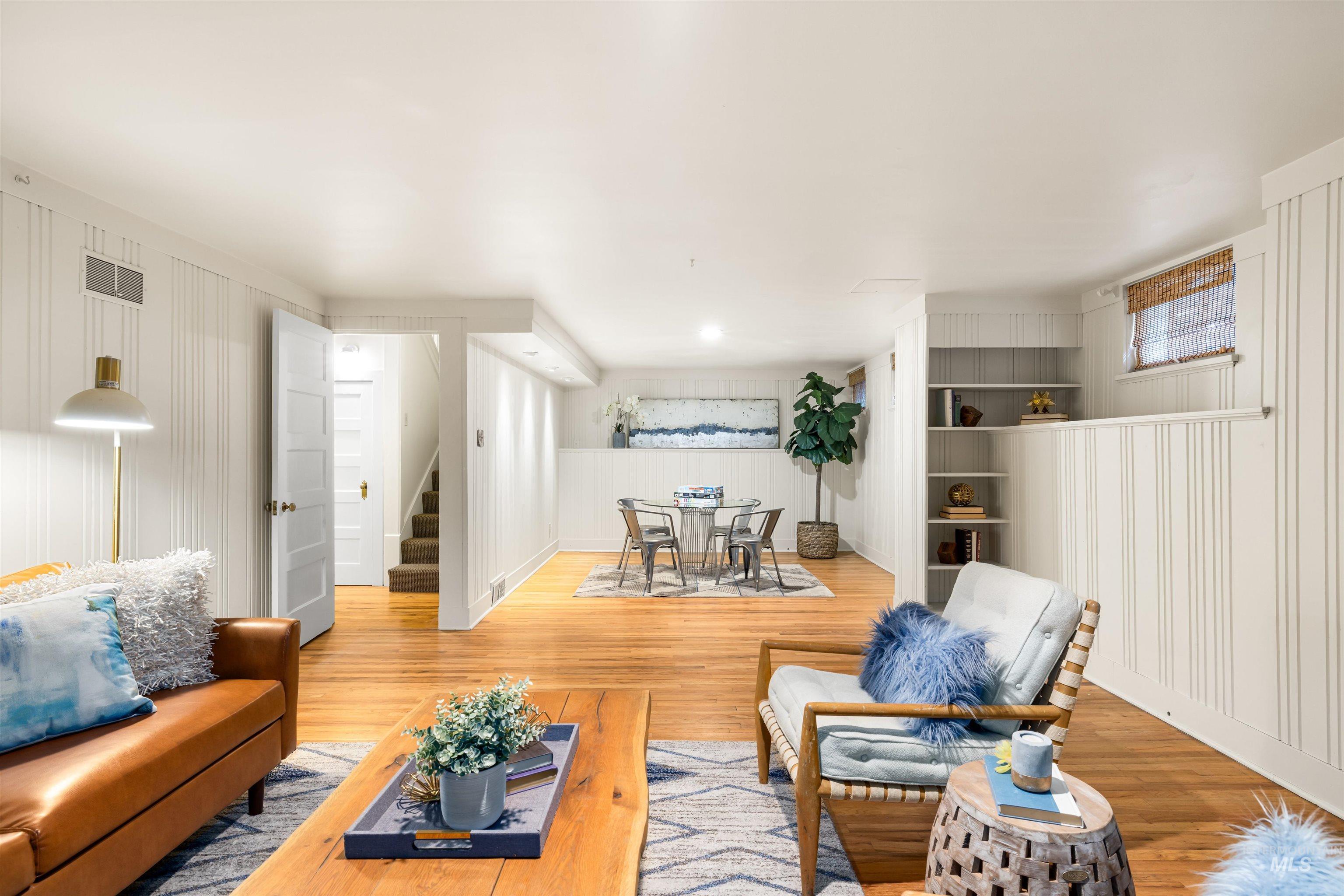 Living room featuring wood finished floors and stairway