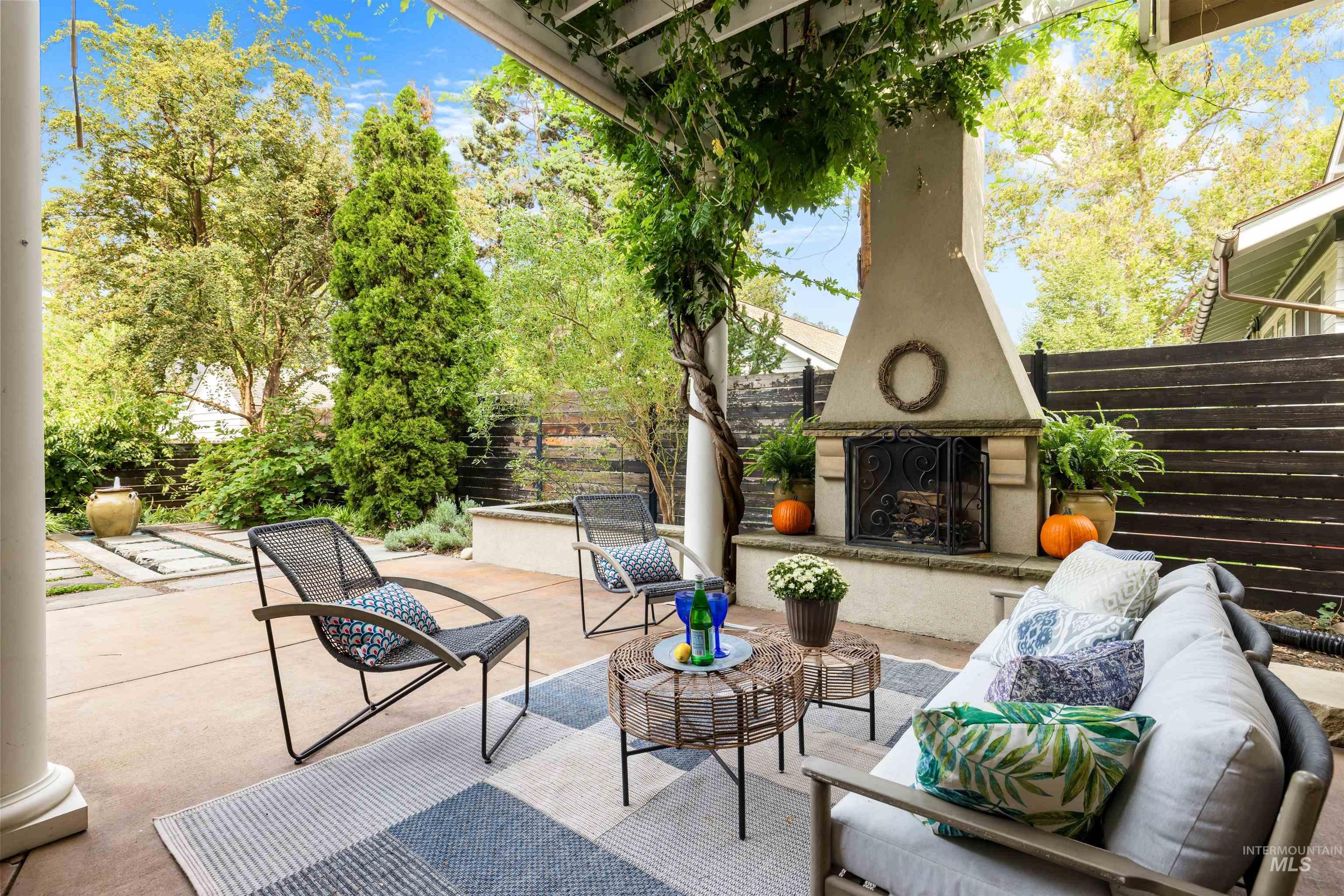 View of patio with an outdoor living space with a fireplace