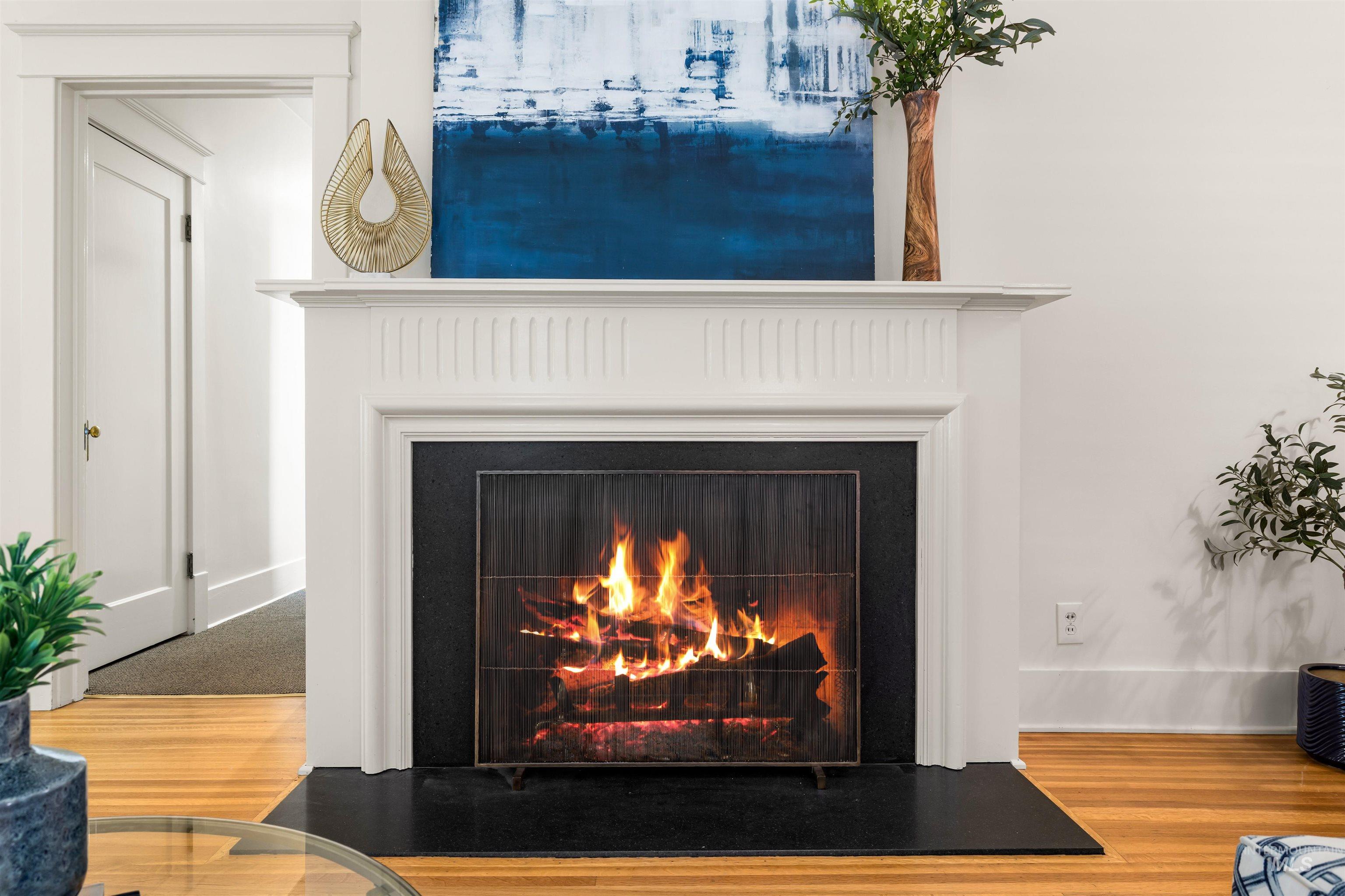 Detailed view of wood finished floors and a fireplace with flush hearth