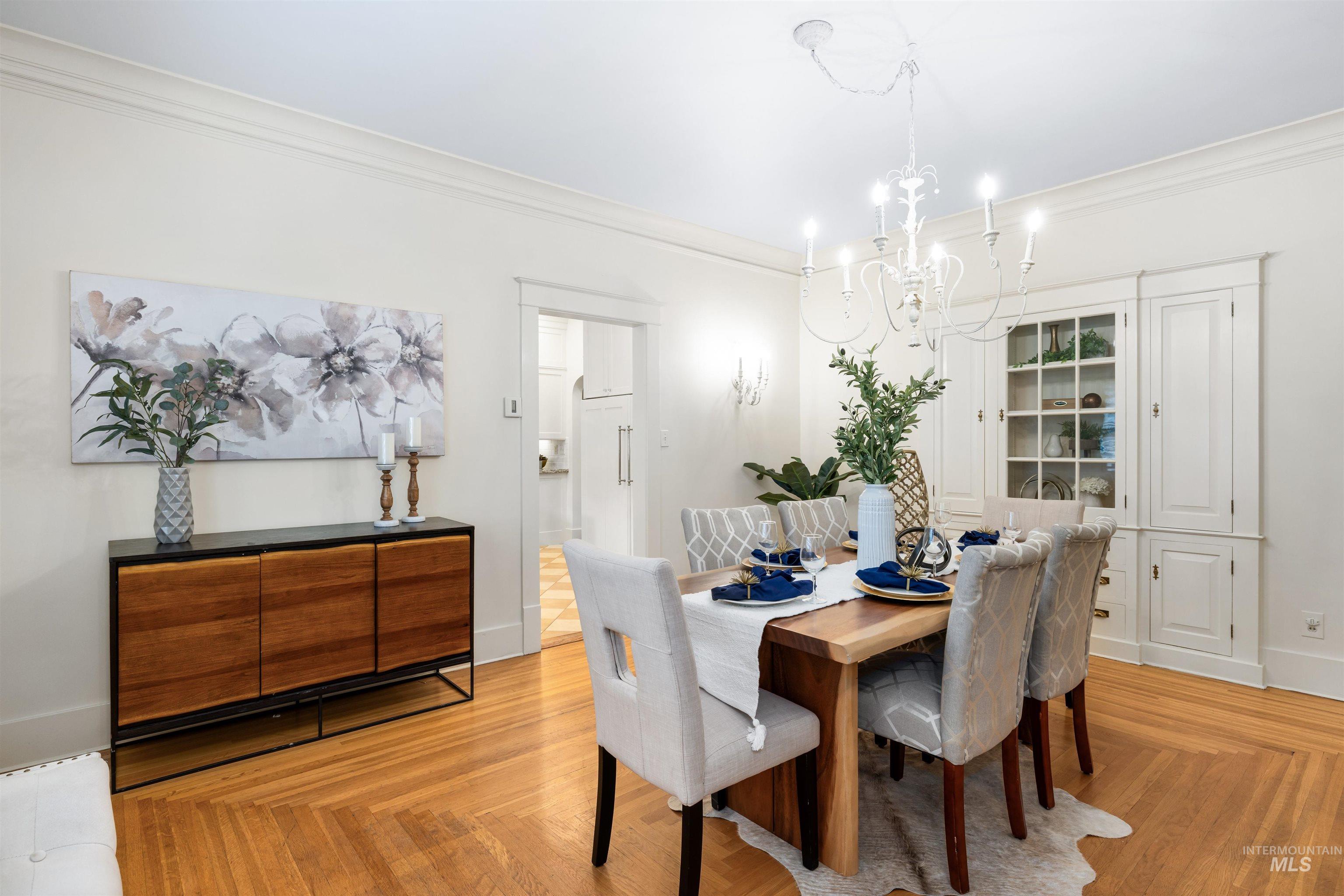 Dining space featuring crown molding and a chandelier