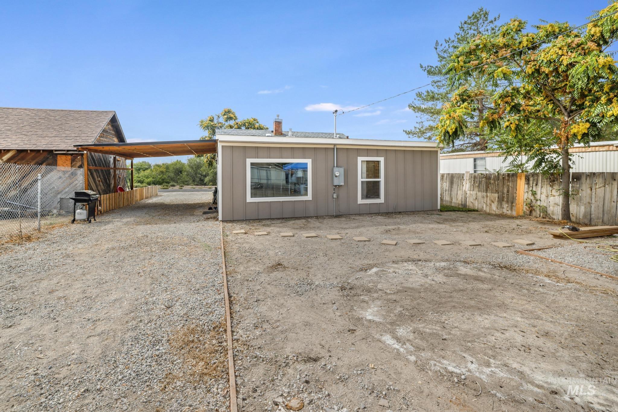 Rear view of house featuring a carport