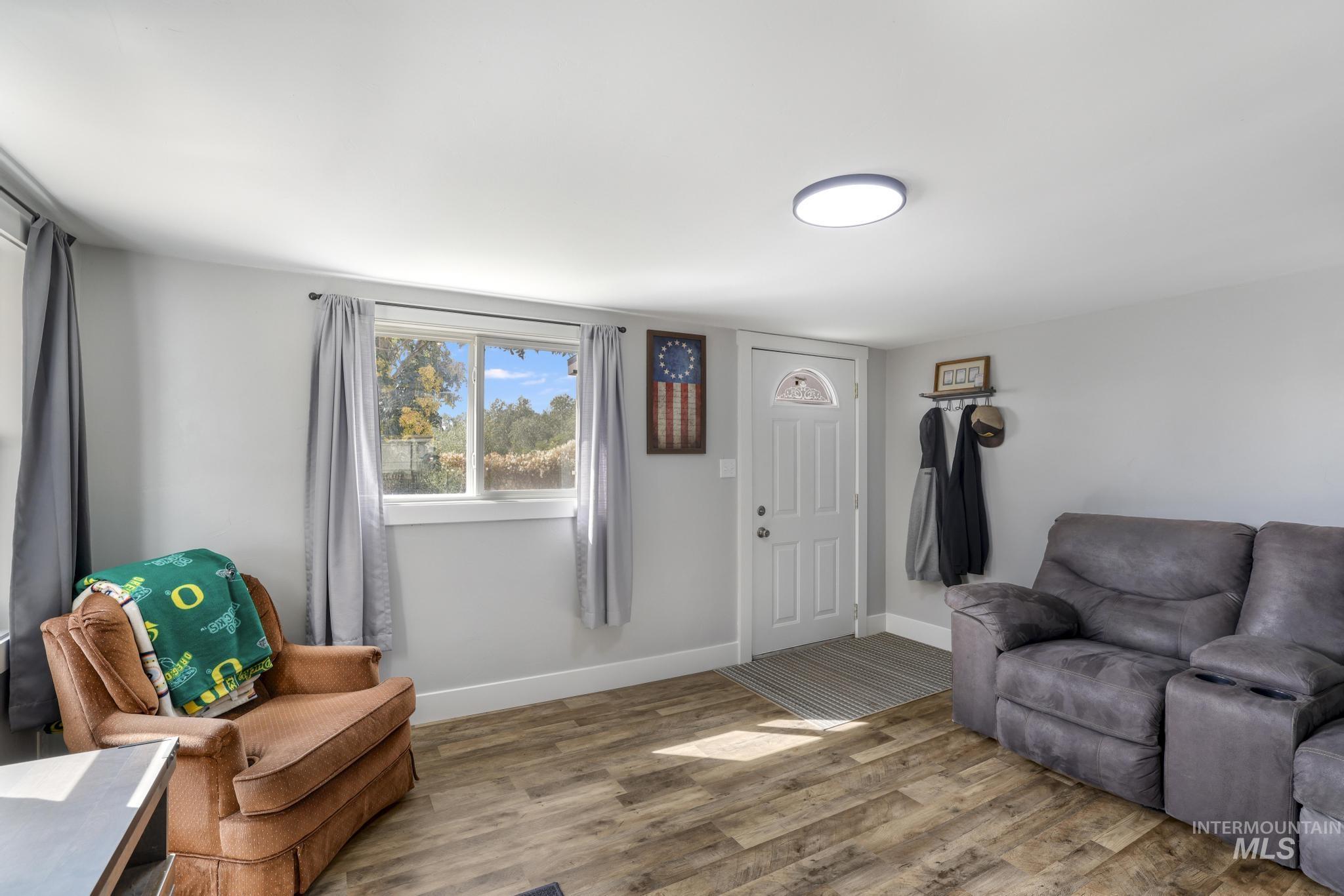 Living area with wood finished floors and baseboards