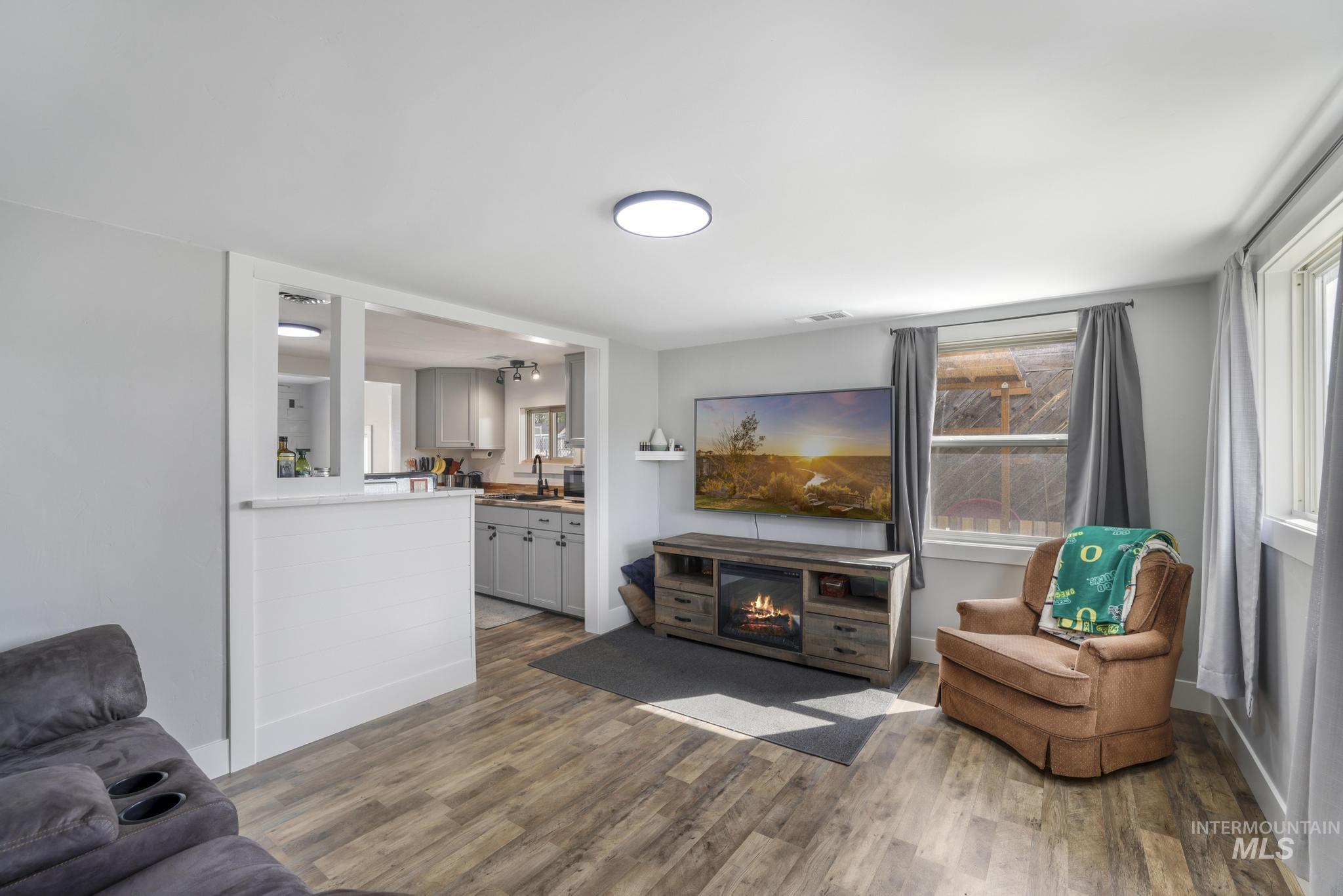 Living room featuring a fireplace and dark wood finished floors