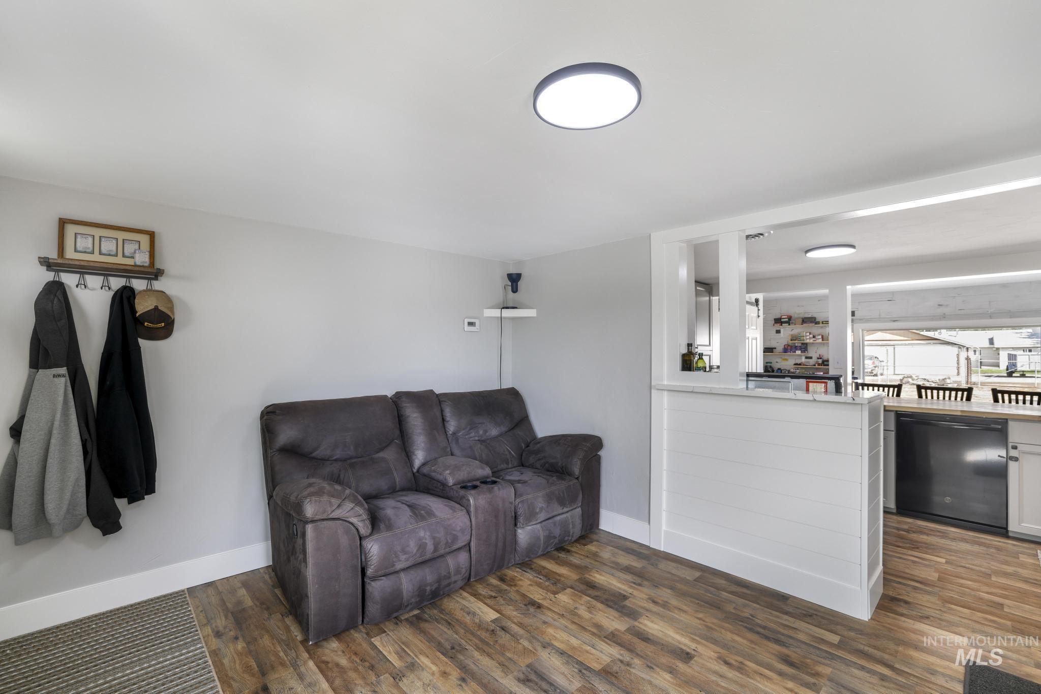Living room with dark wood-type flooring and bar area