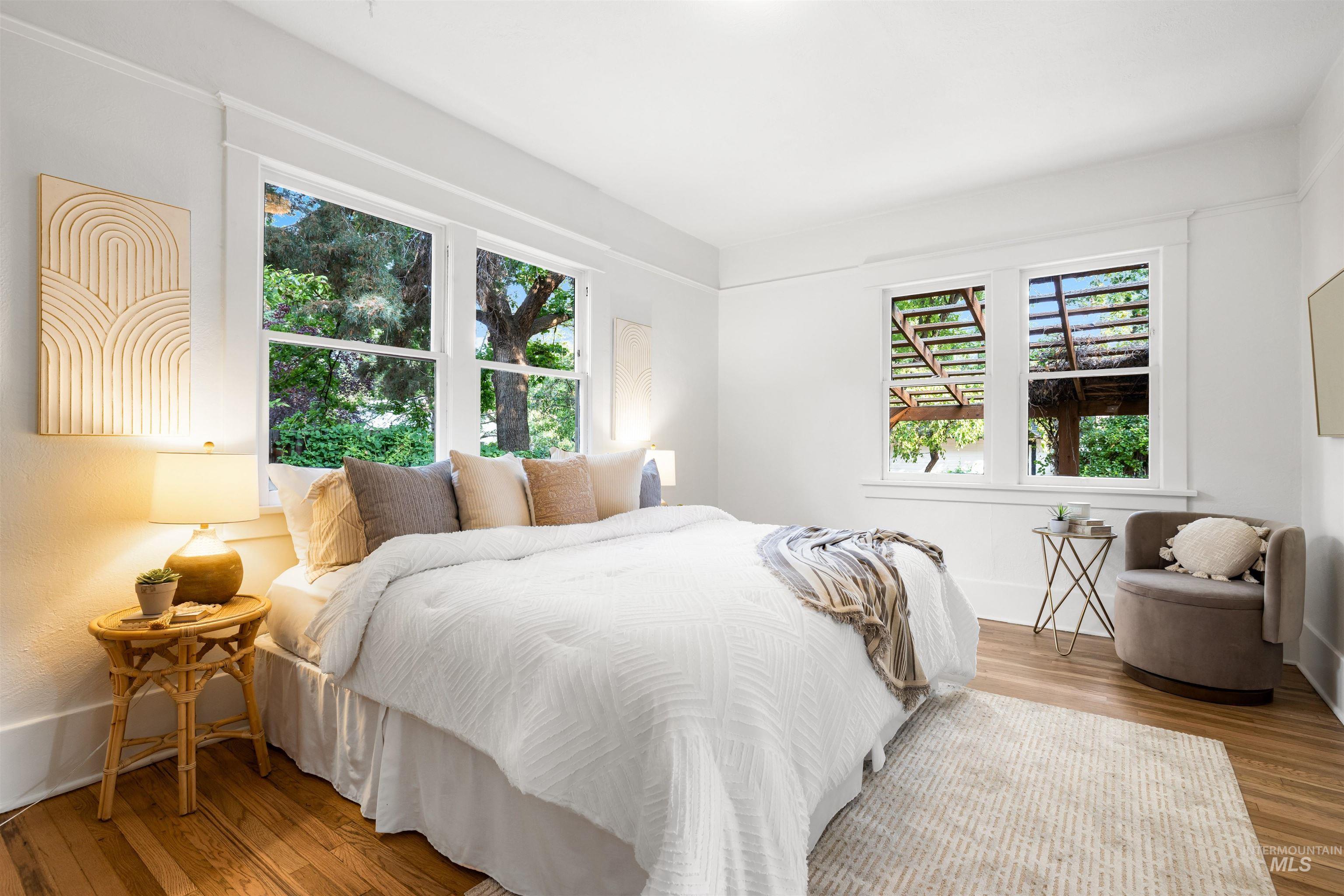 Bedroom with wood finished floors and baseboards