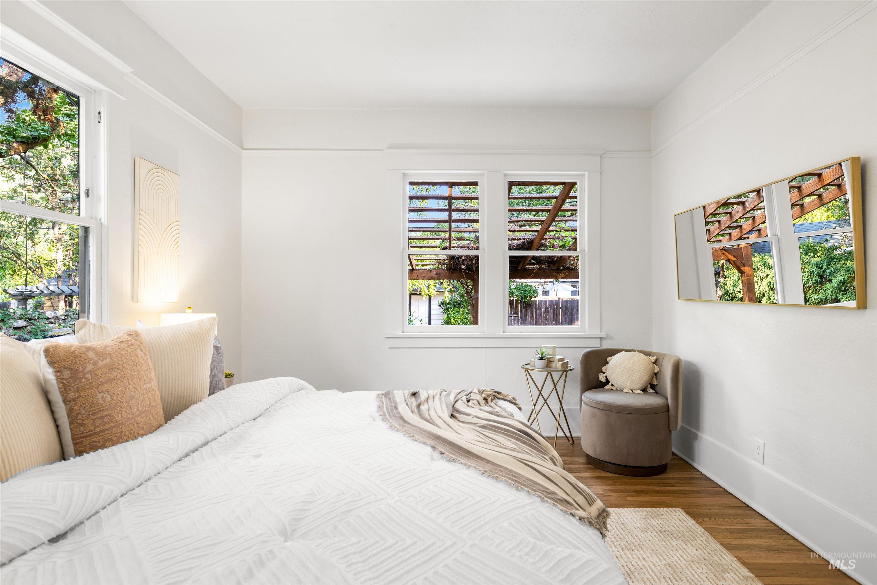 Bedroom featuring wood finished floors and baseboards
