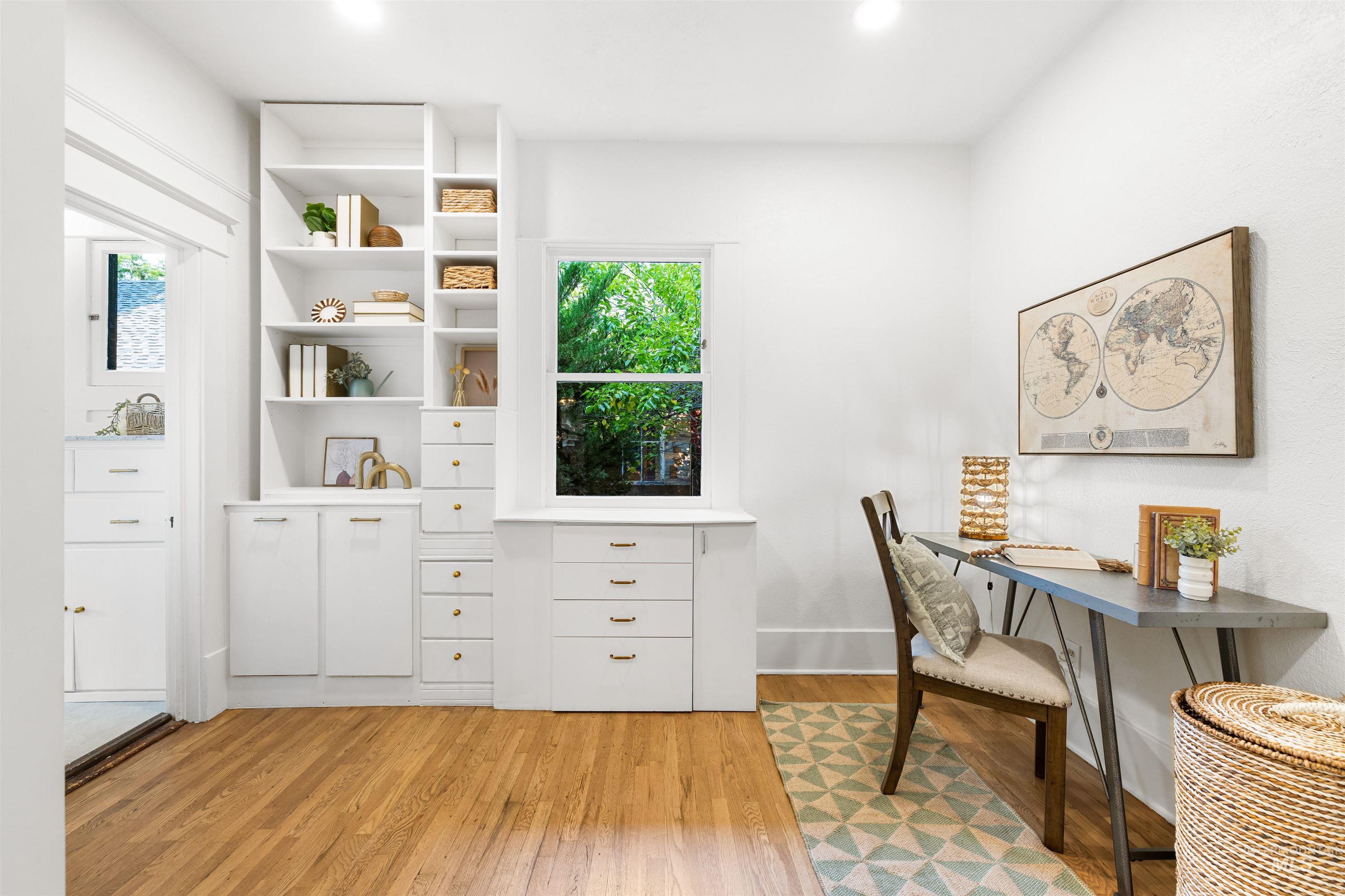 Home office with light wood-style floors and baseboards