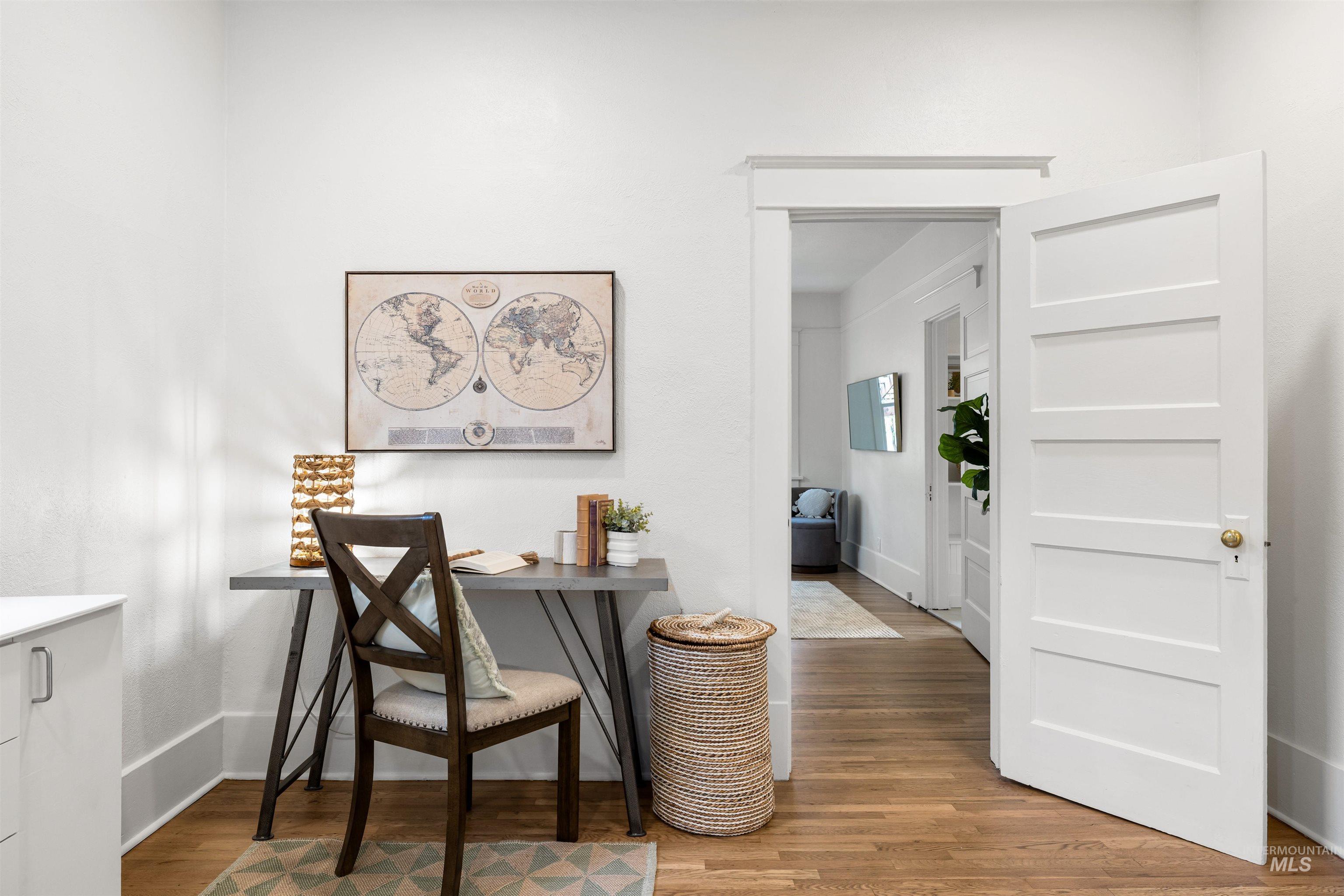 Office area with light wood-style flooring and baseboards