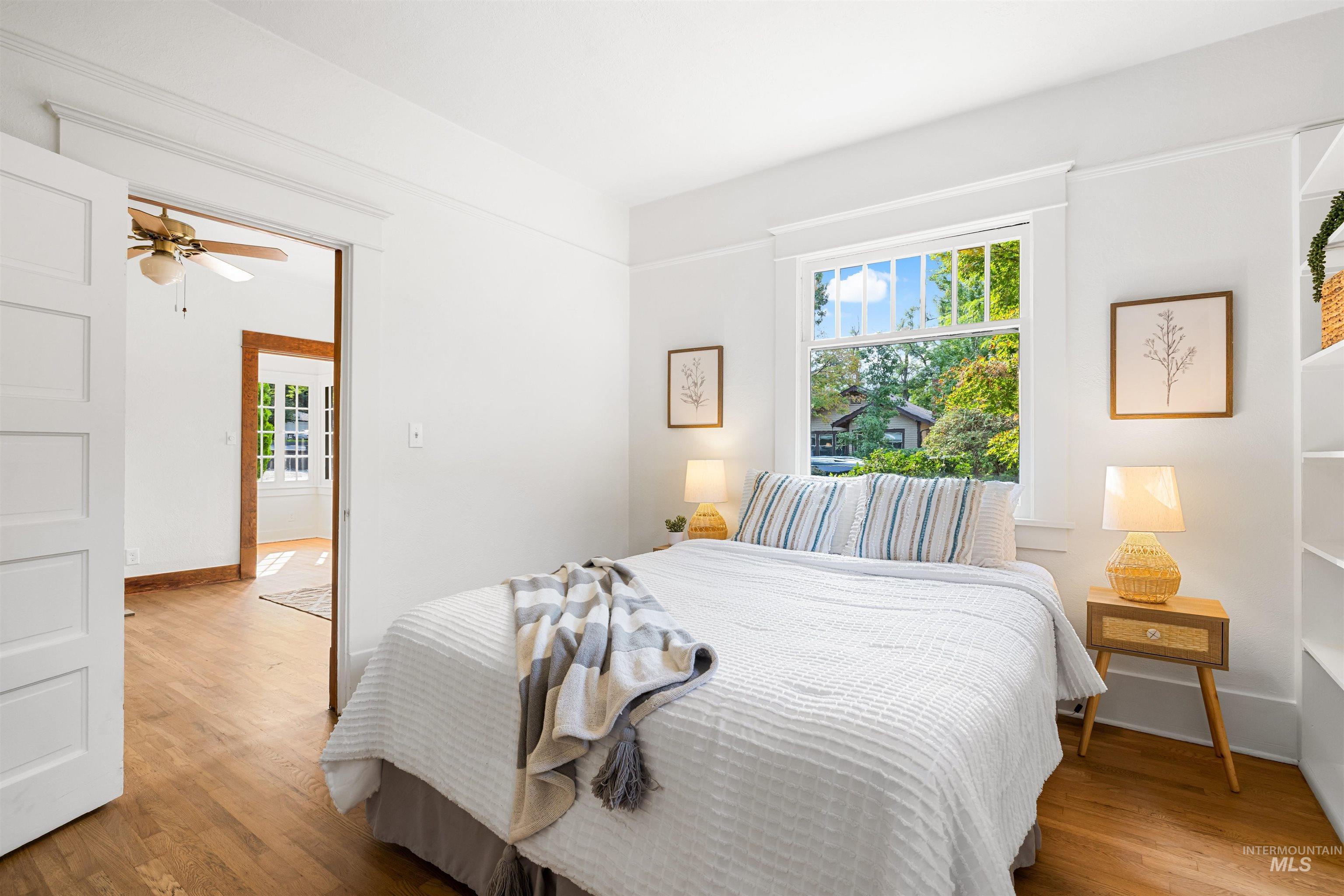 Bedroom featuring wood finished floors and baseboards