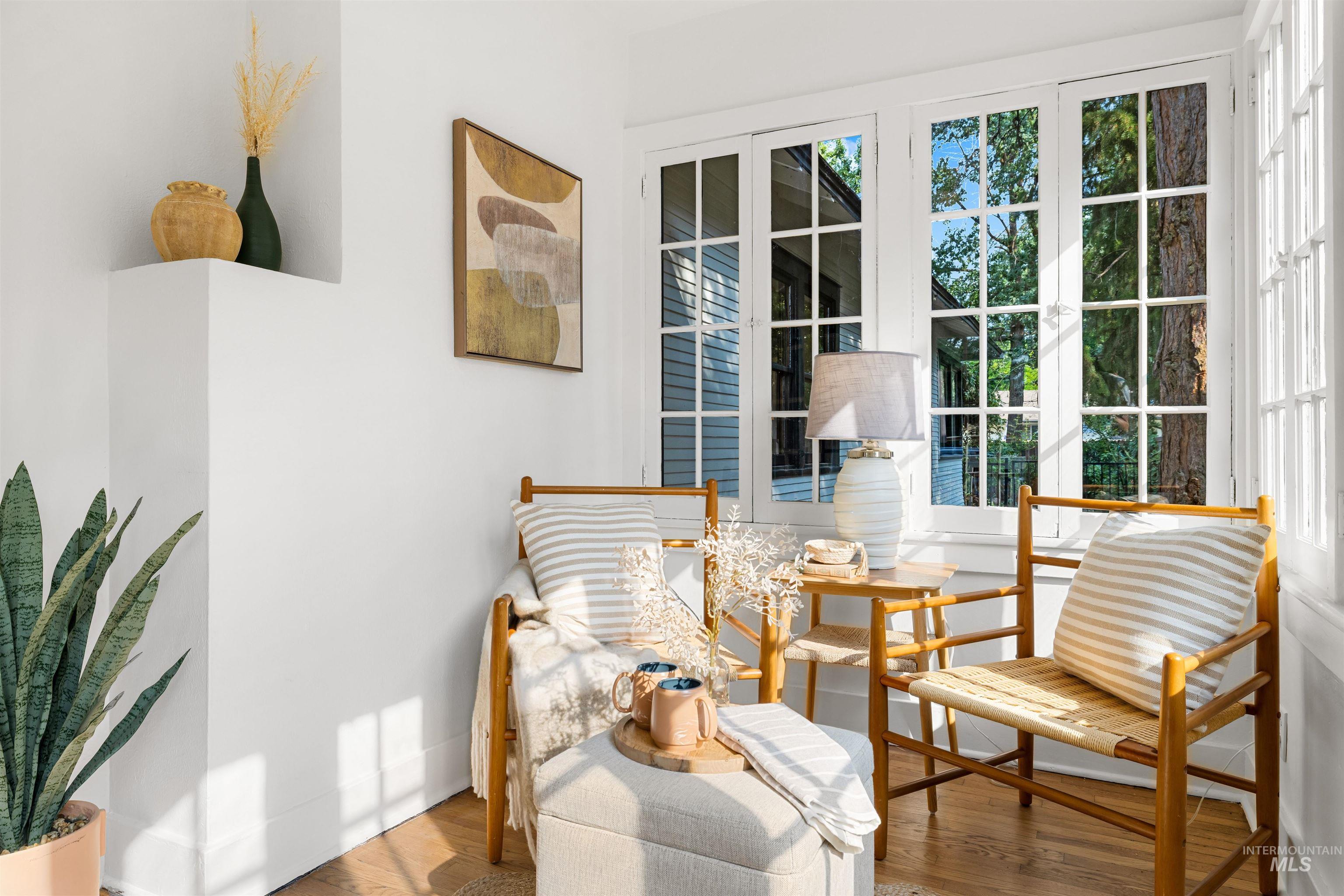 Living area with wood finished floors and baseboards