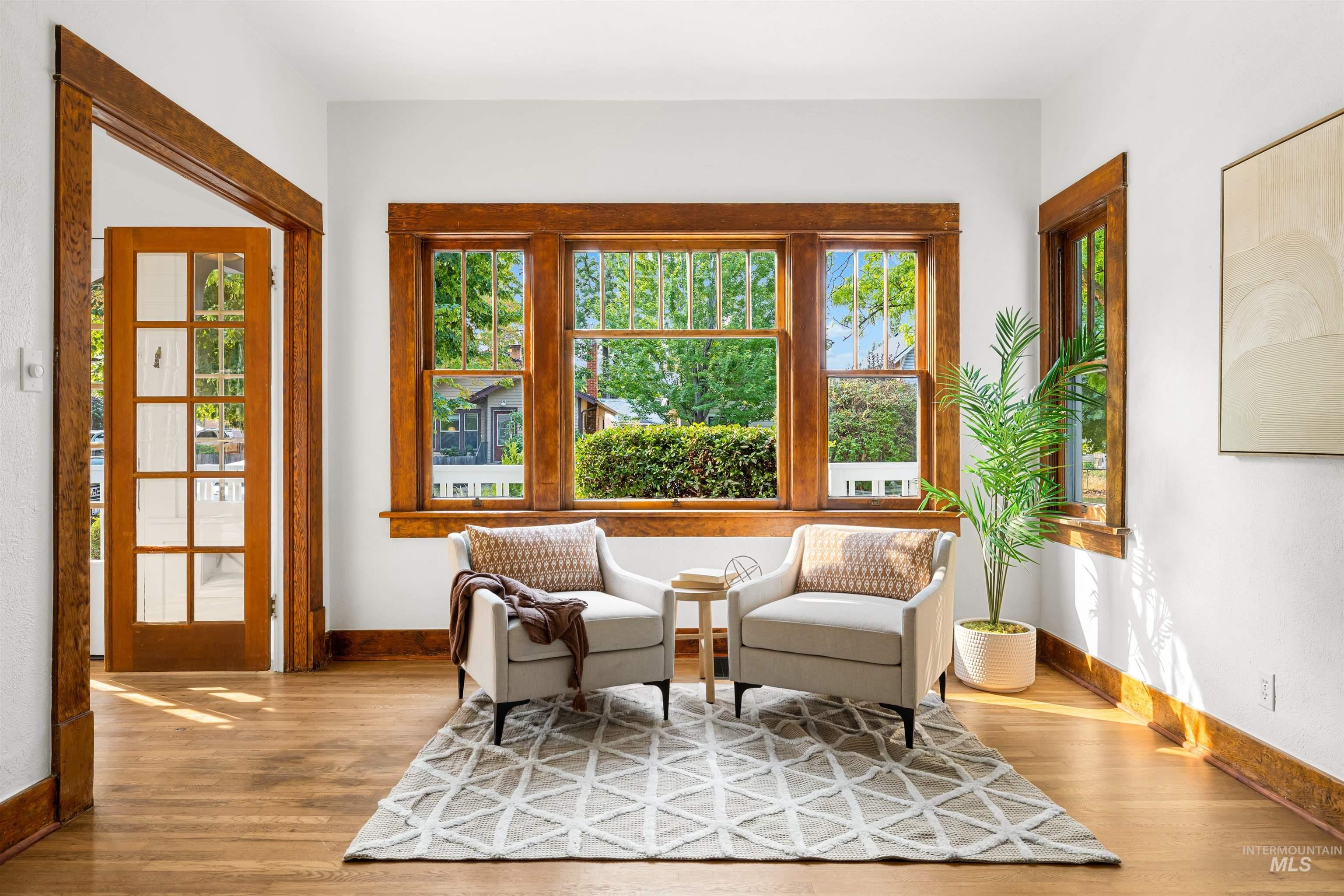 Sitting room with baseboards and wood finished floors