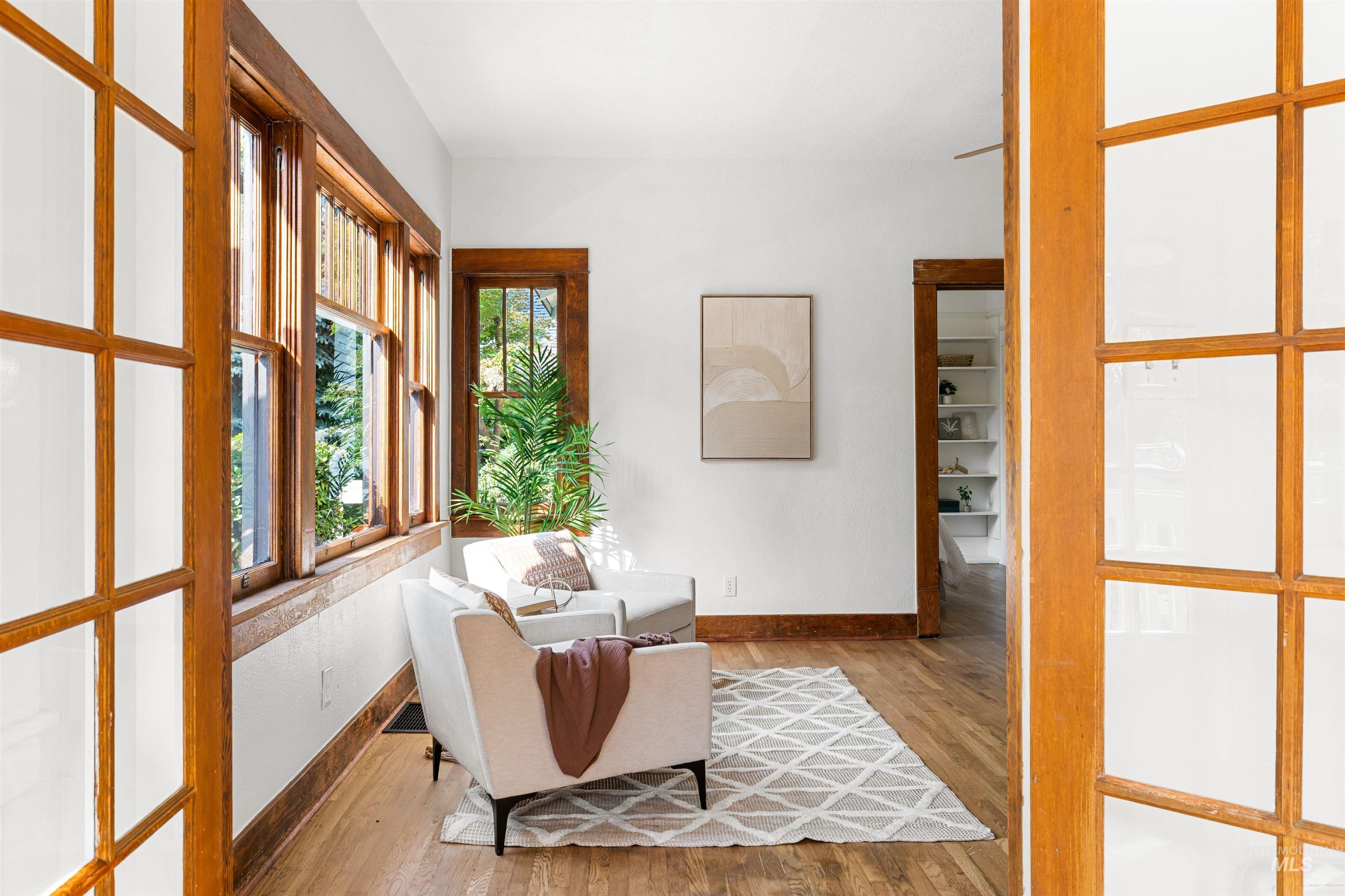 Sitting room with wood finished floors and baseboards