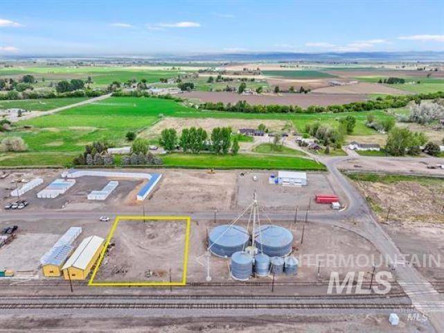 Aerial view of property's location with property parcel outlined and an industrial area