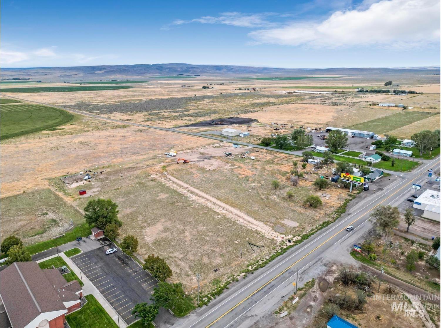 Aerial overview of property's location with rural landscape and mountains