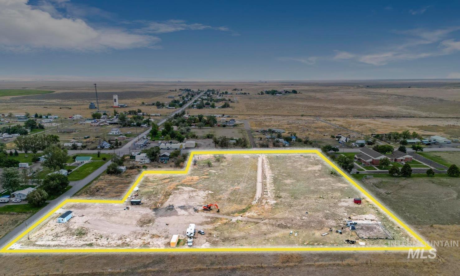 Aerial view of sparsely populated area with property parcel outlined