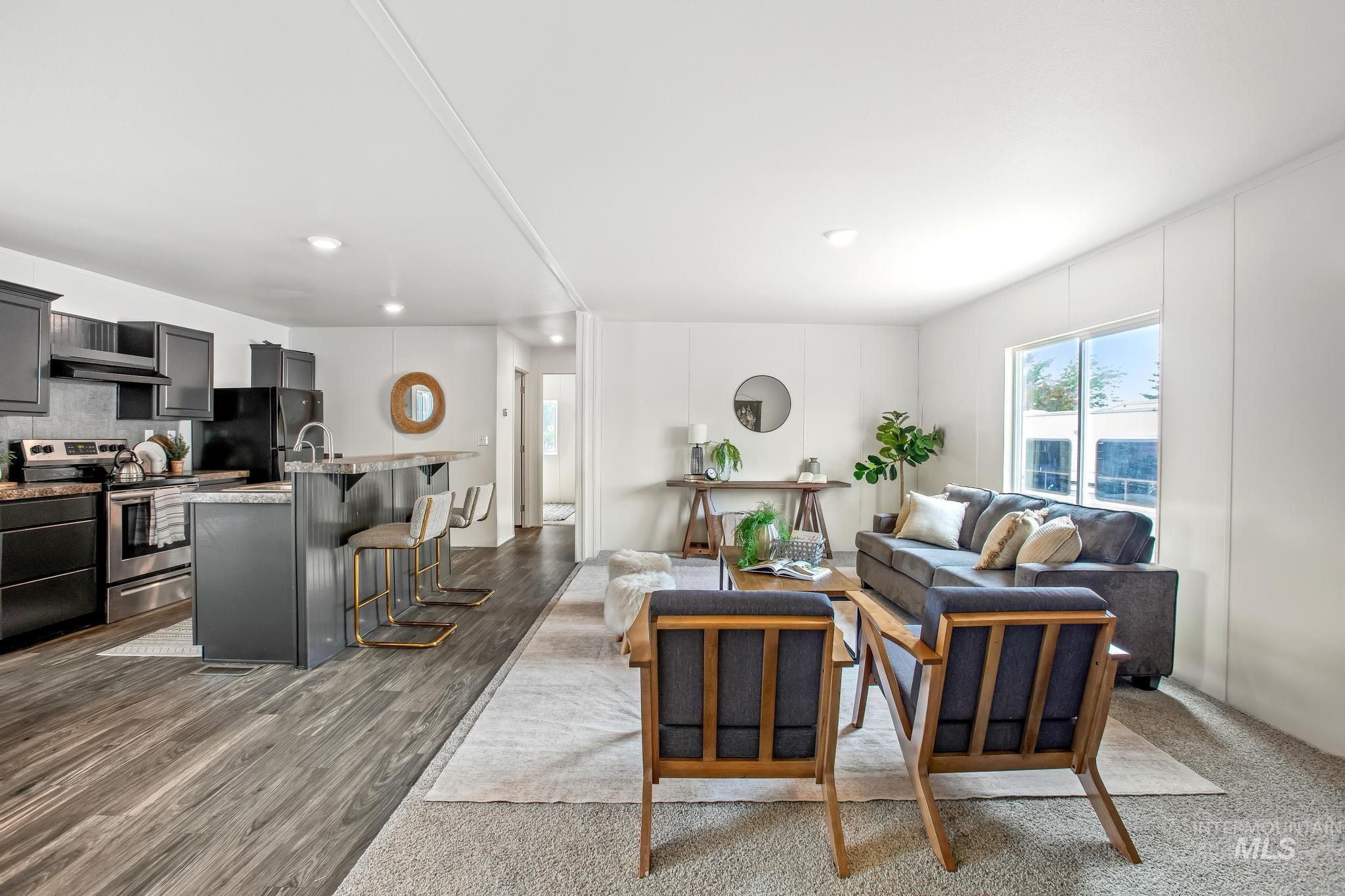 Living room with dark wood finished floors and recessed lighting
