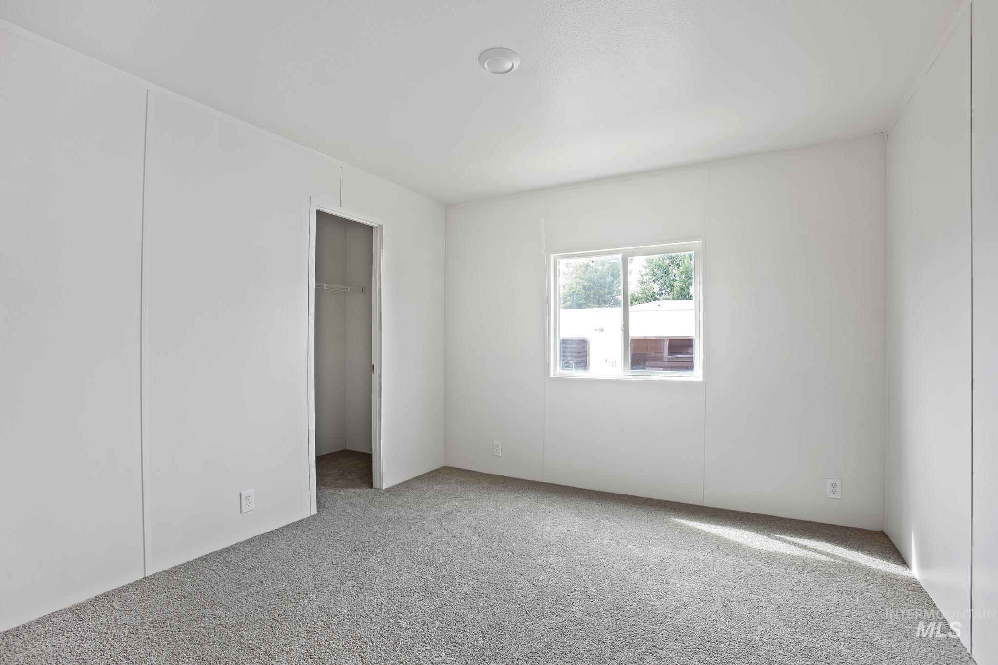 Unfurnished bedroom featuring a spacious closet and carpet