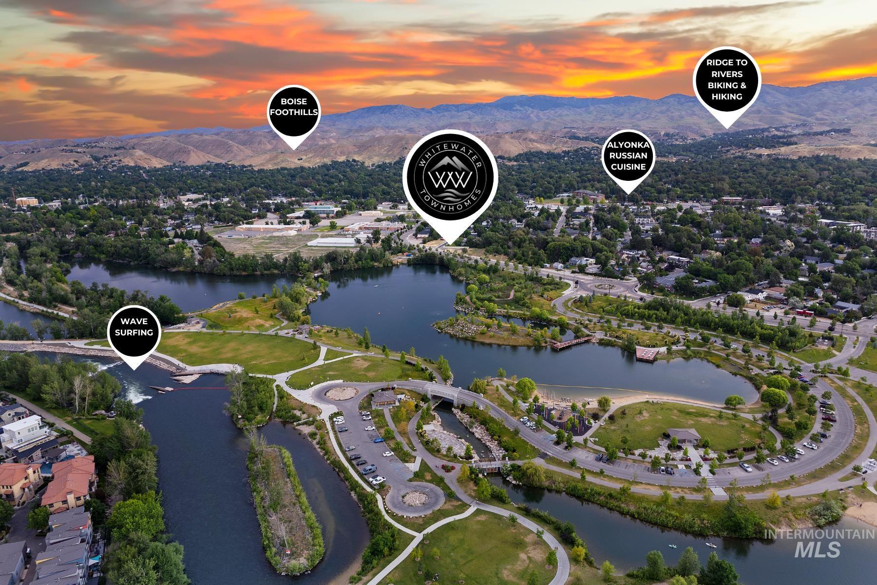 Aerial view of property and surrounding area featuring a water and mountain view
