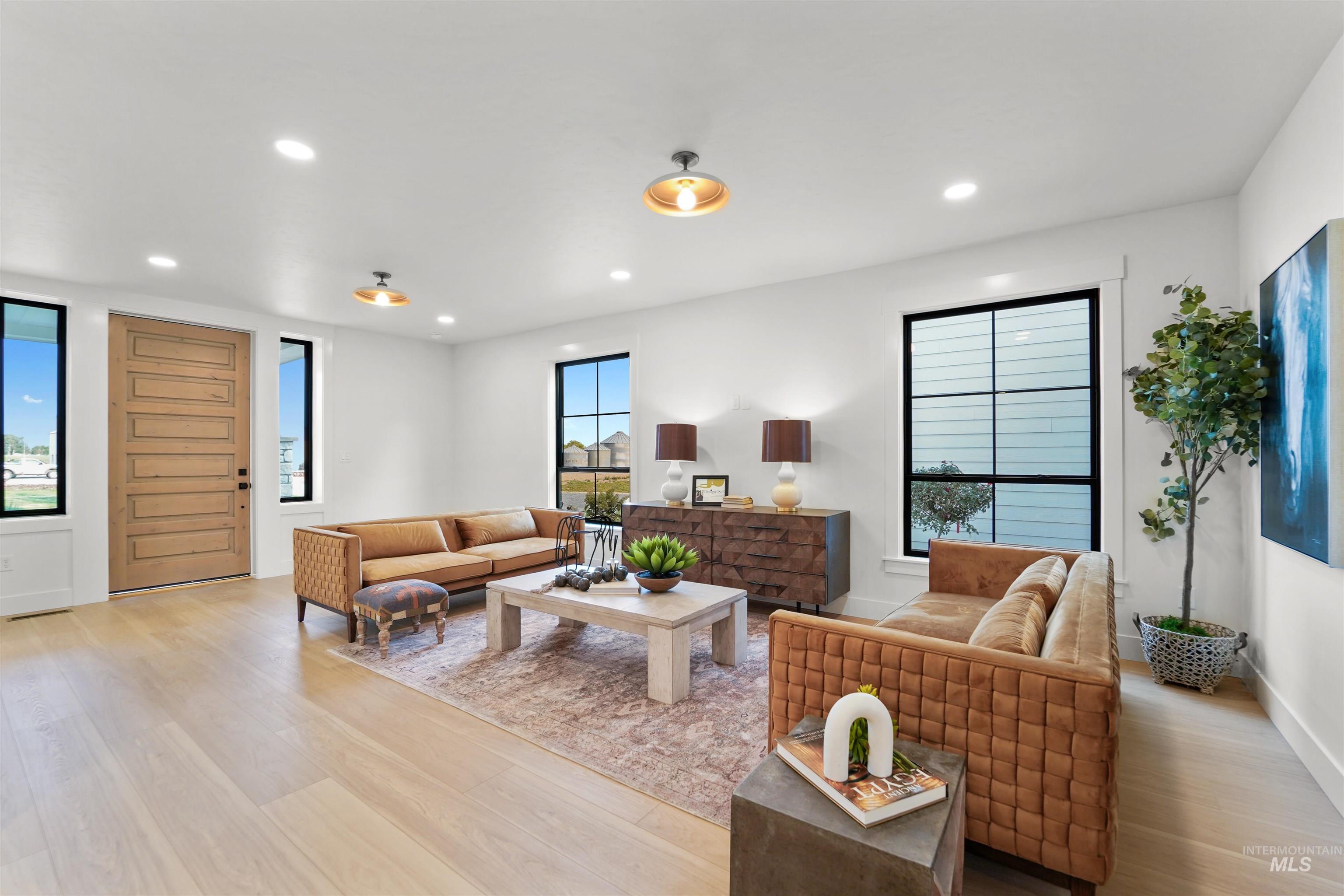 Living area featuring plenty of natural light, light wood-style floors, and recessed lighting