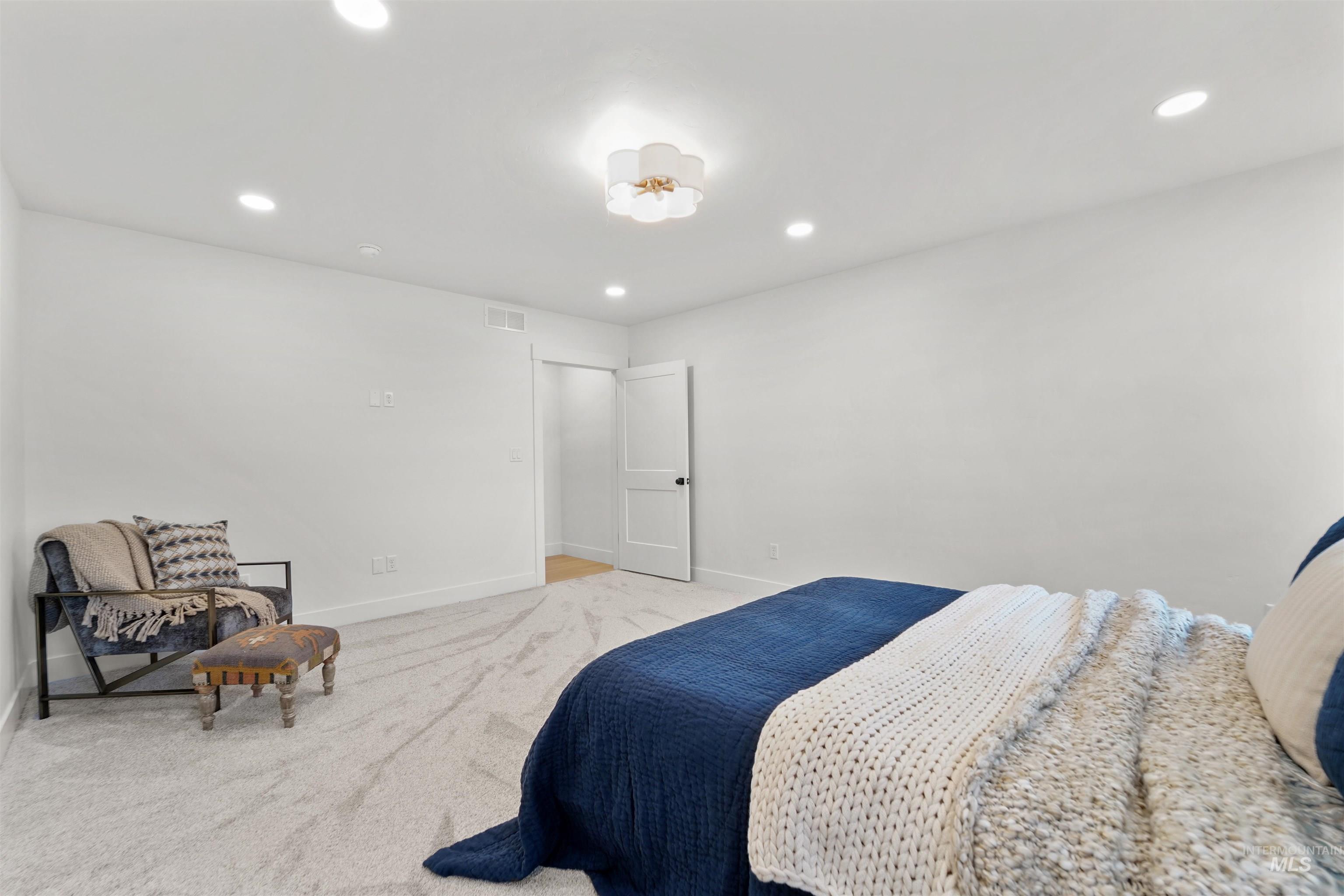 Carpeted bedroom featuring recessed lighting