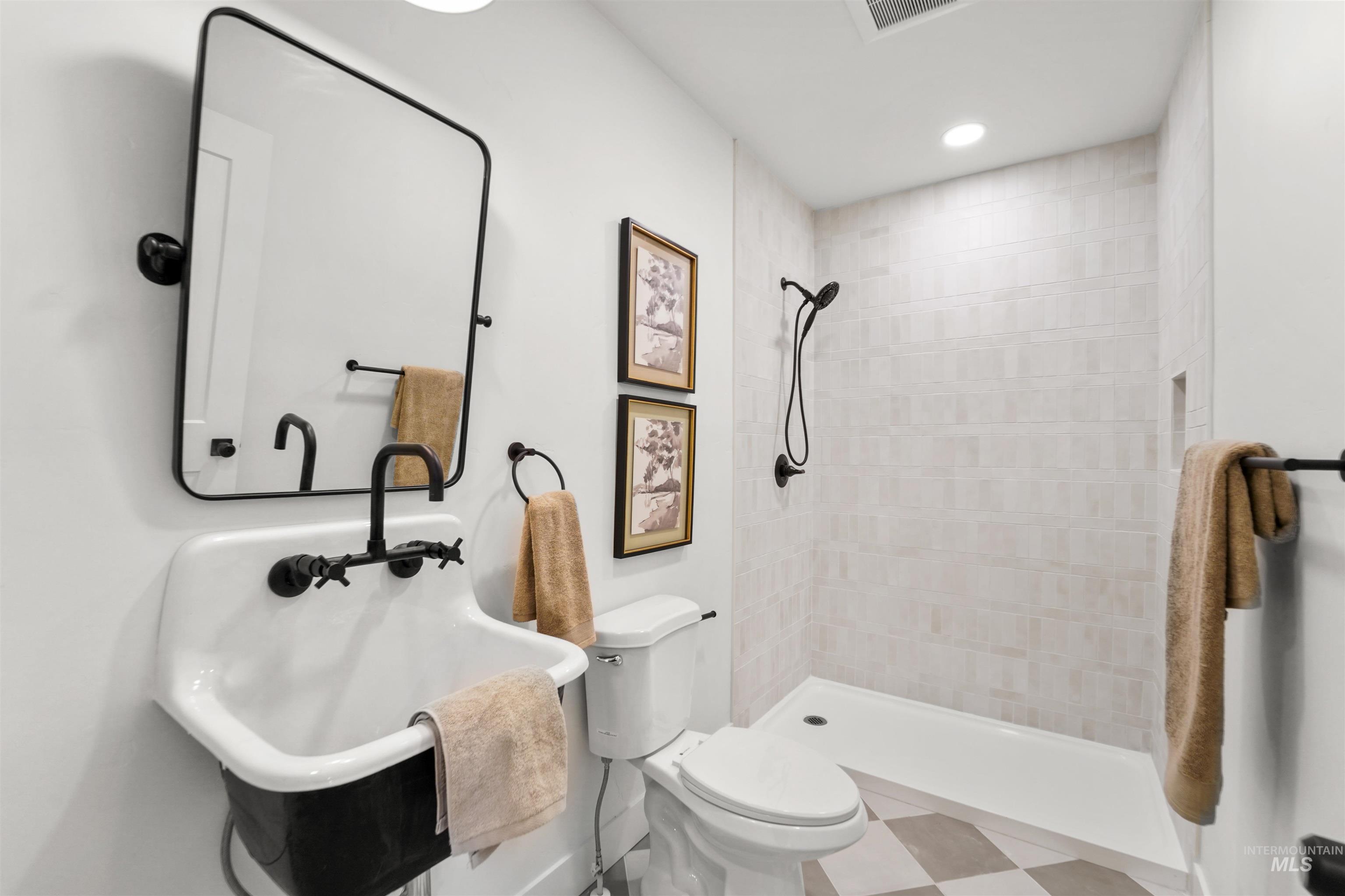 Bathroom featuring a shower stall and recessed lighting