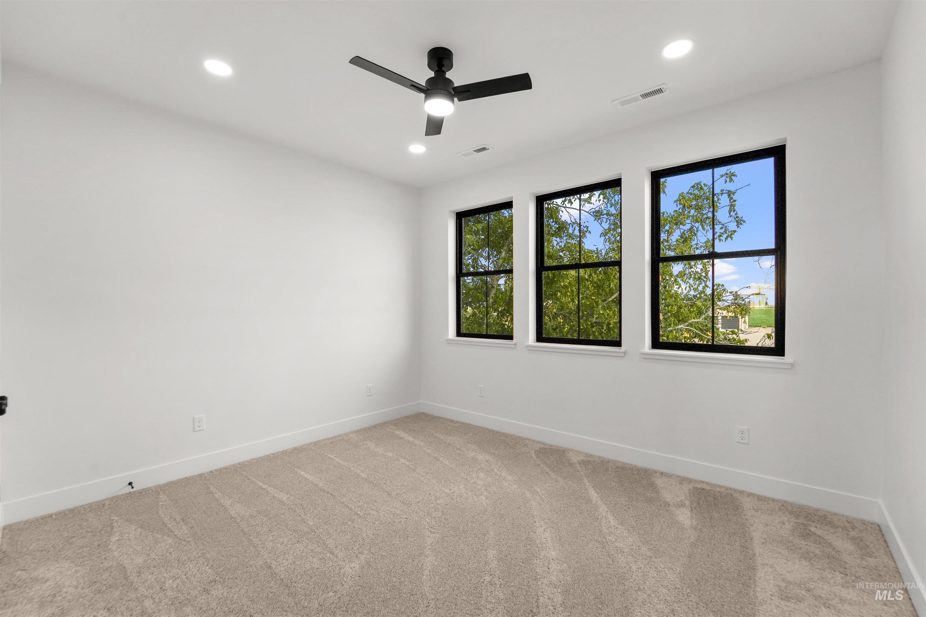 Unfurnished room with light colored carpet, recessed lighting, and a ceiling fan