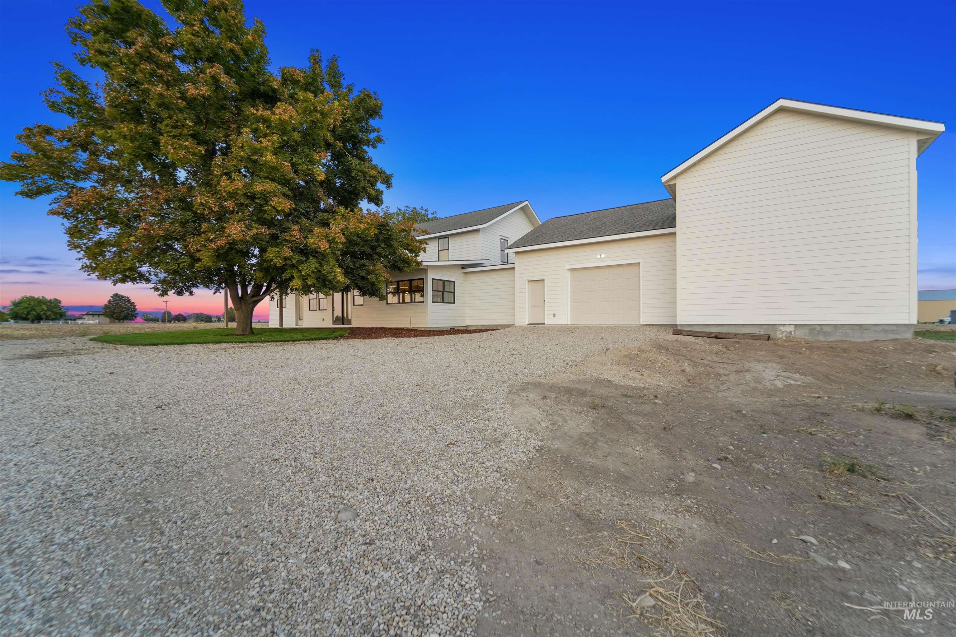 View of front of house featuring an attached garage and driveway