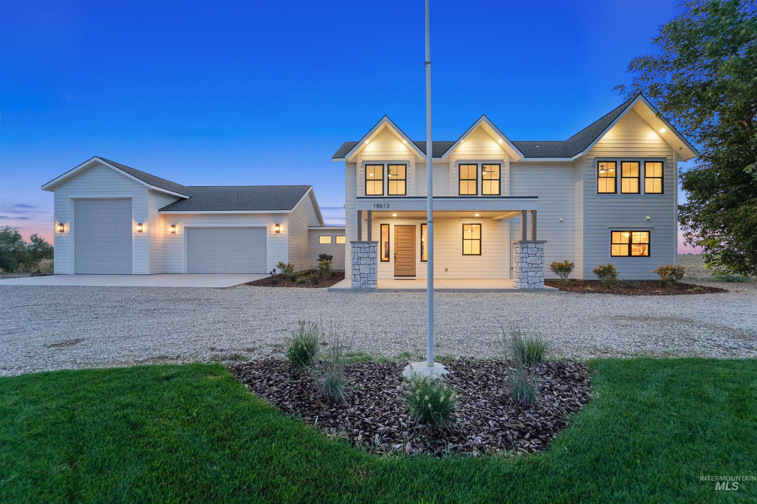 View of front of home with a porch, concrete driveway, an attached garage, and a yard