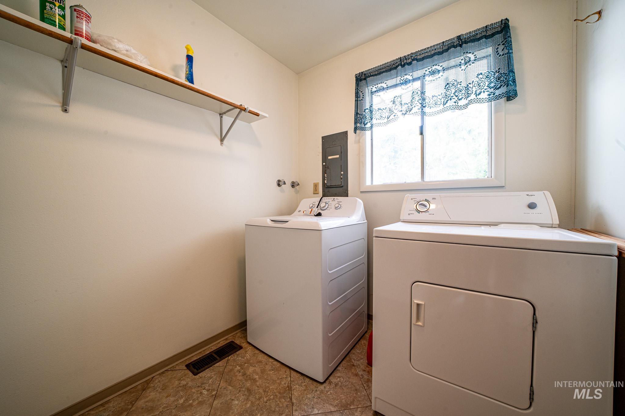 Laundry area with washing machine and dryer and electric panel
