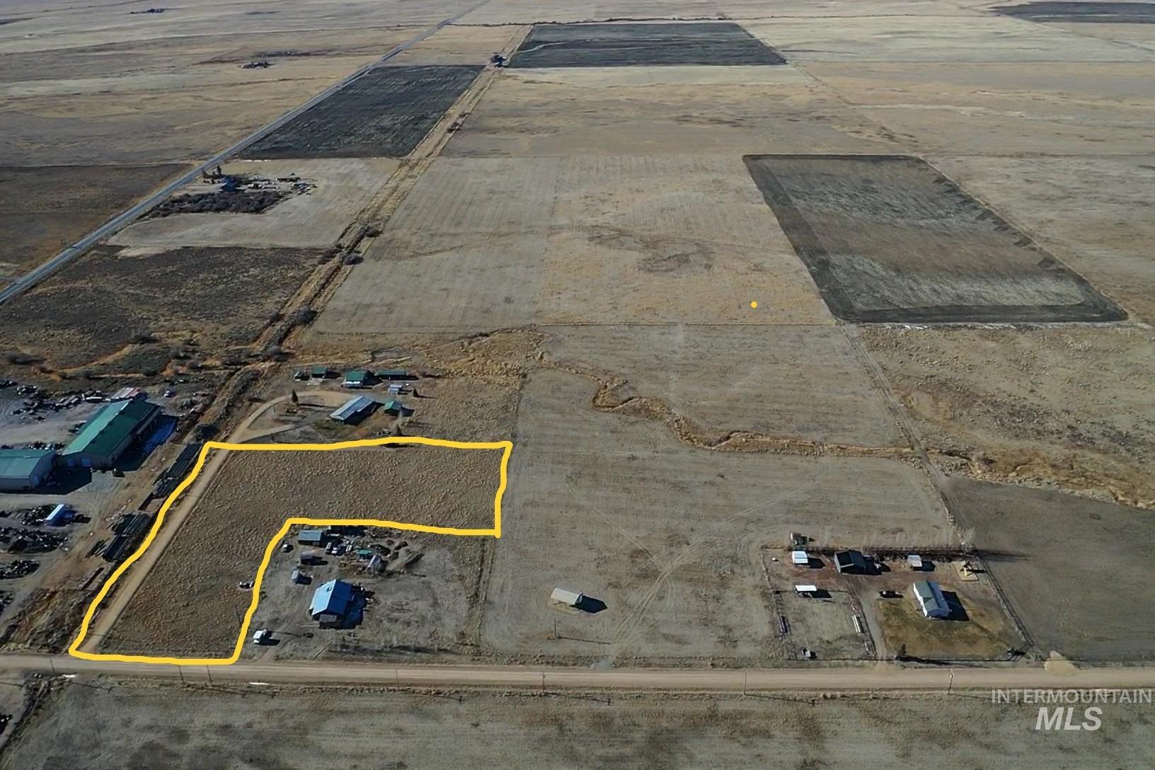 Aerial view of sparsely populated area featuring property boundaries highlighted