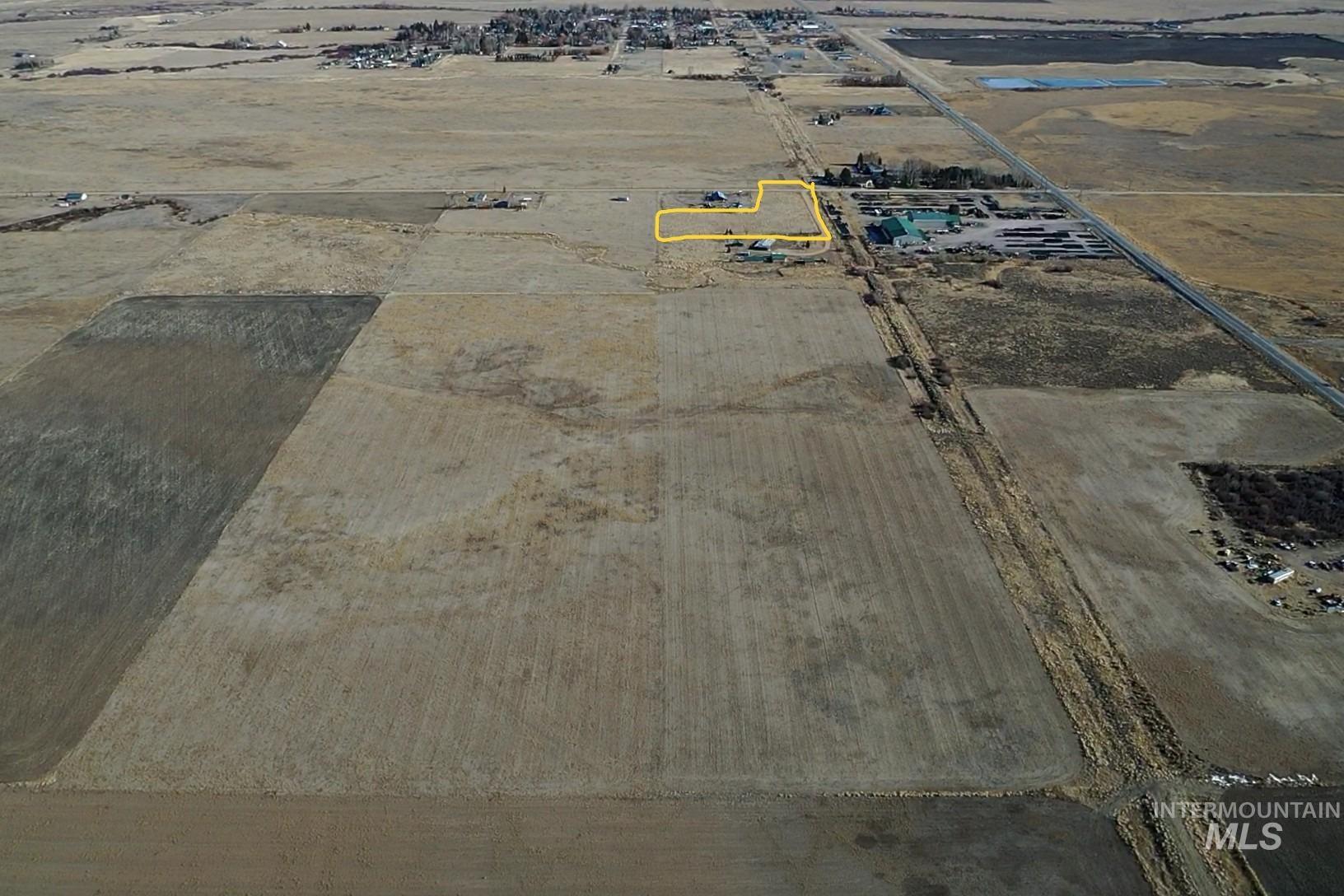 Aerial view of property and surrounding area featuring property parcel outlined and rural landscape