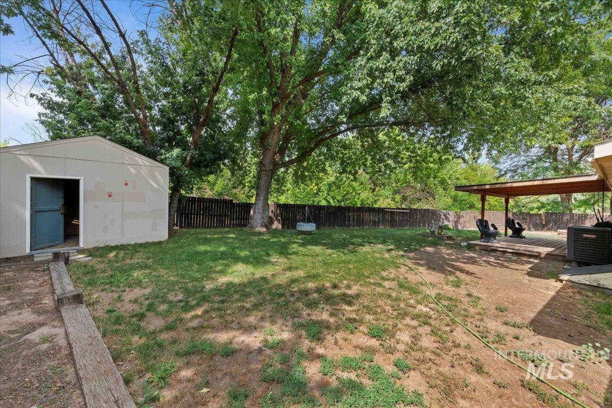 Fenced backyard with an outbuilding