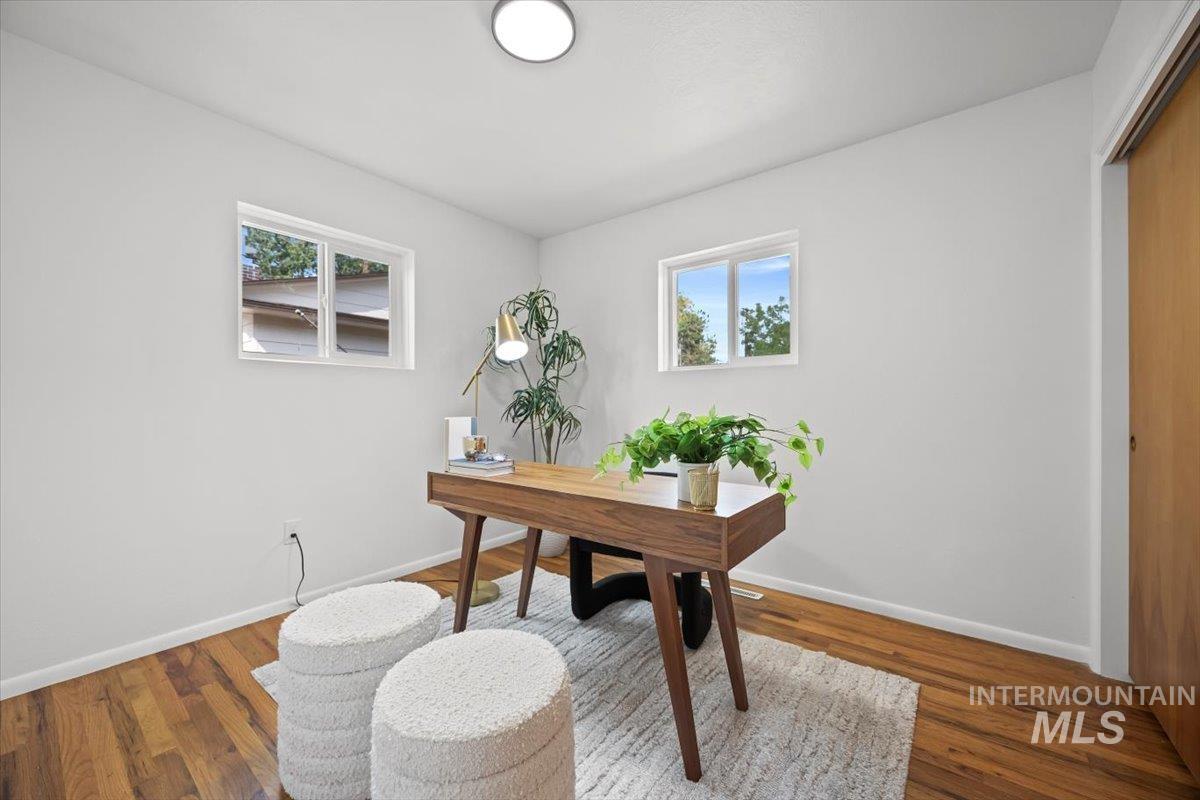 Office featuring healthy amount of natural light and wood finished floors