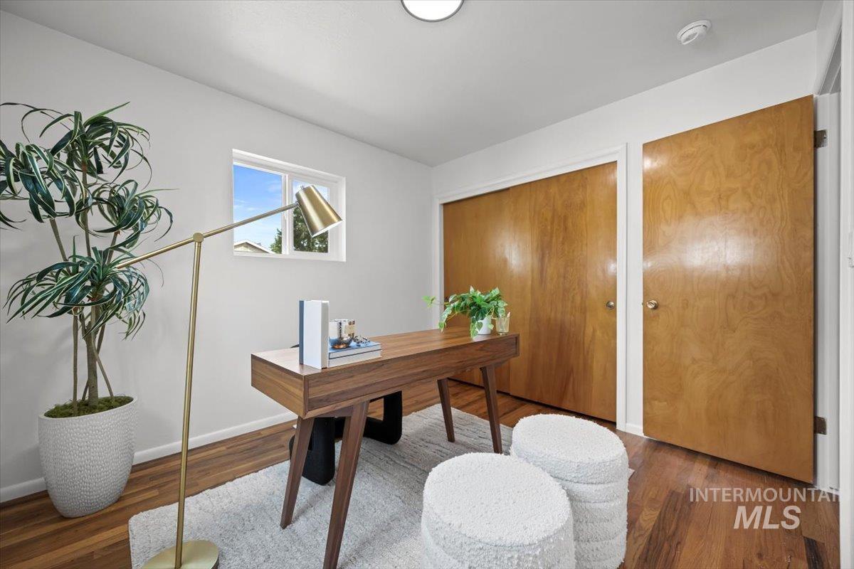 Office area with wood finished floors and baseboards