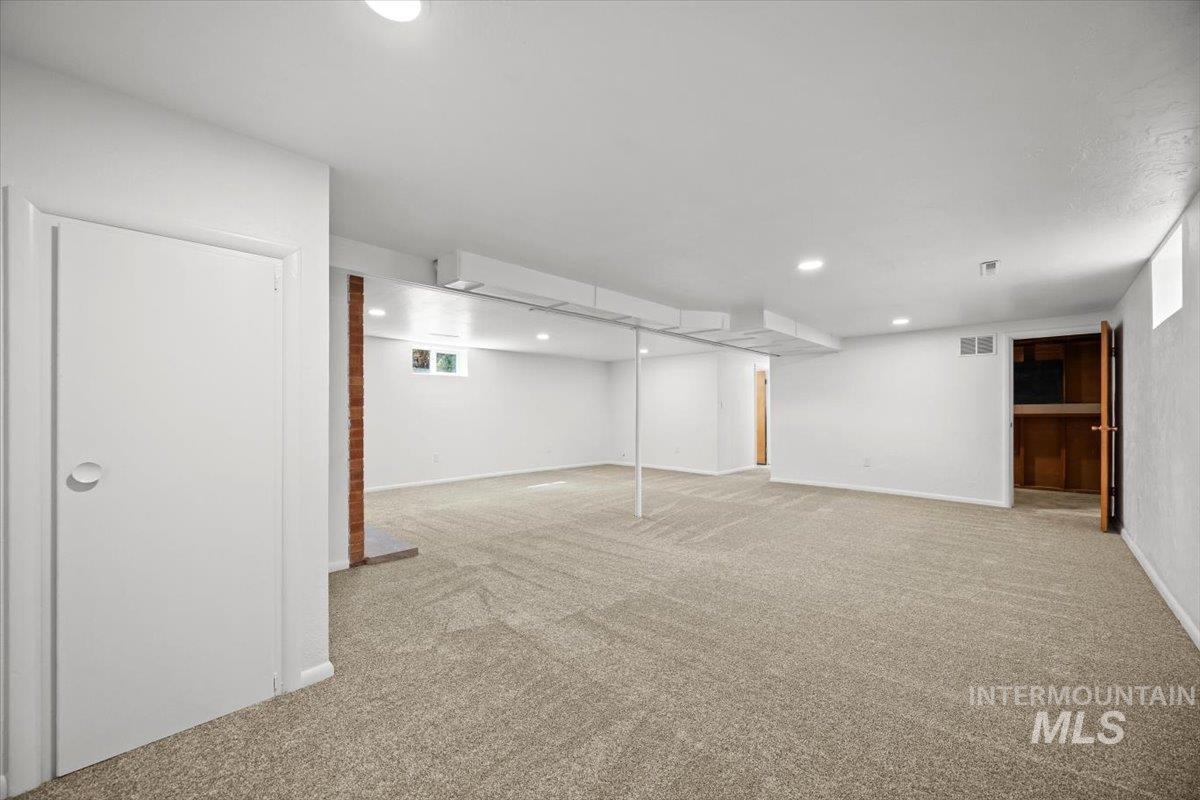 Below grade area featuring light carpet and recessed lighting