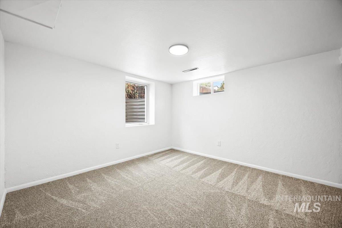 Basement with baseboards and carpet flooring