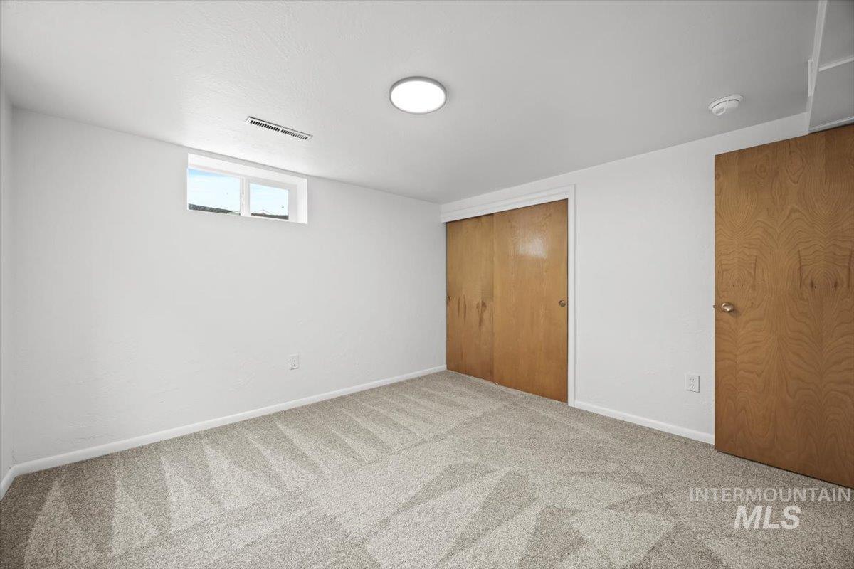 Unfurnished bedroom featuring a closet and carpet