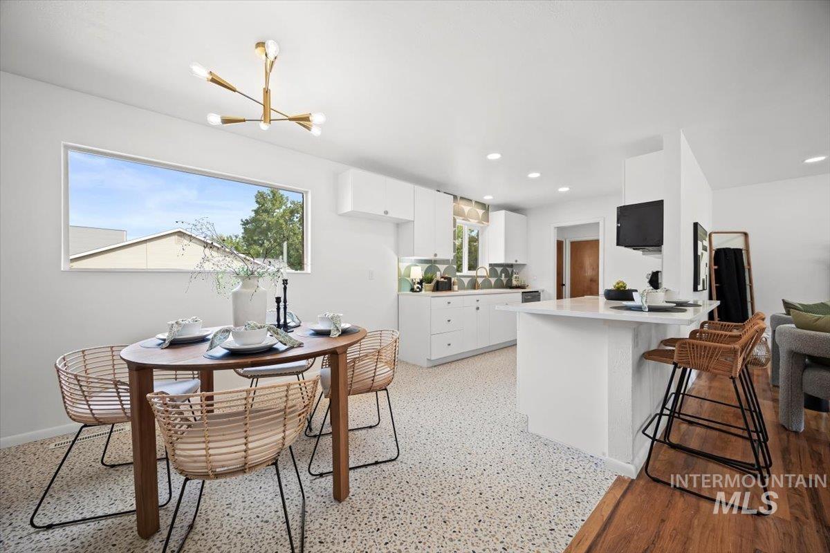 Dining space with a chandelier and recessed lighting